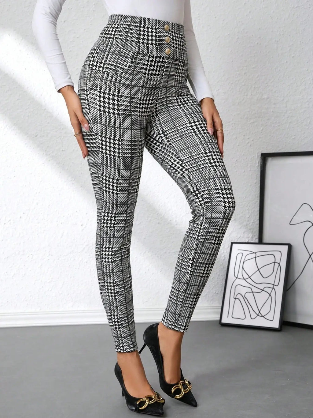 High waist plaid slim-fit pants in black and white with gold-tone button accents