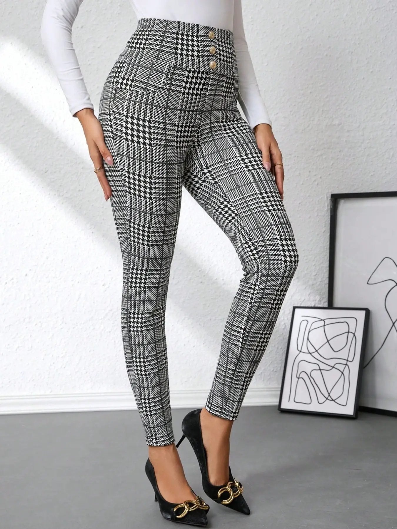 High waist plaid slim-fit pants in black and white with gold-tone button accents