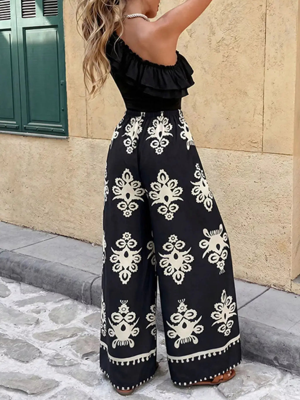Two-piece outfit set: One-Shoulder Ruffled Crop Top and Wide-Leg Printed Pants in black with white damask print.