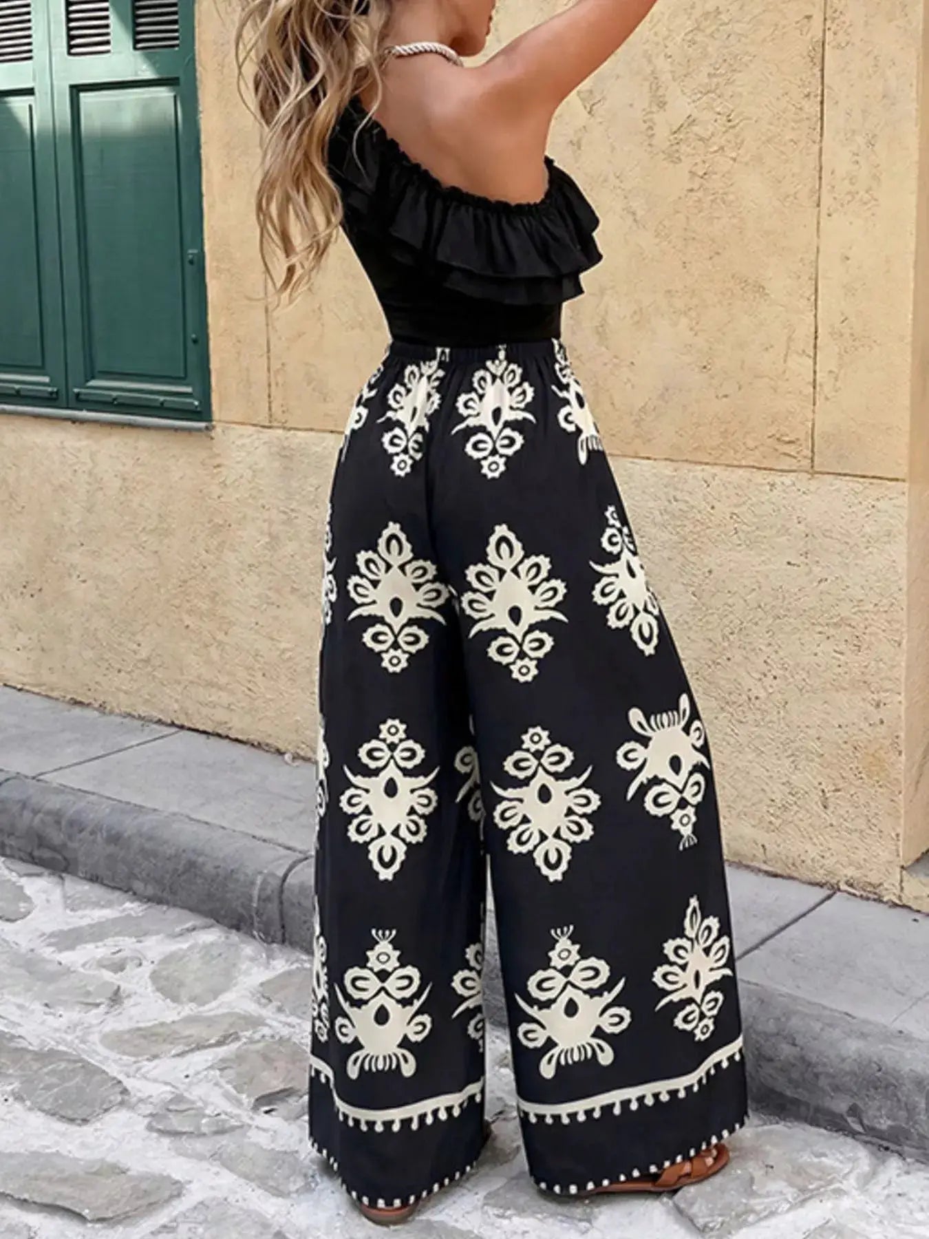 Two-piece outfit set: One-Shoulder Ruffled Crop Top and Wide-Leg Printed Pants in black with white damask print.