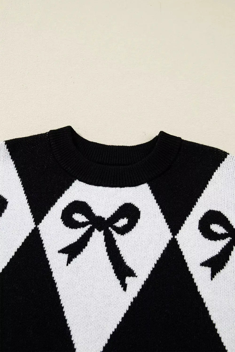 Bow Pattern Long Sleeve Contrast Sweater in black and white with bow motifs and ribbed crew neck