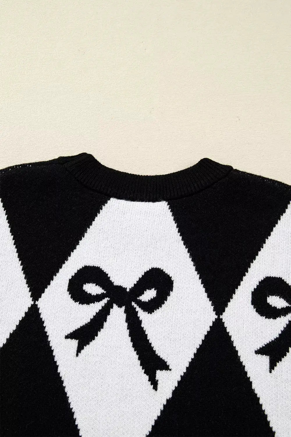 Bow Pattern Long Sleeve Contrast Sweater by Belle Bijouix in black and white argyle knit with bow motif