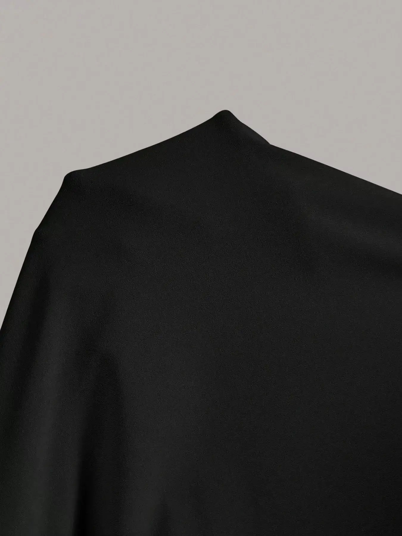 Dress fabric close-up: black stretch material with smooth, matte finish
