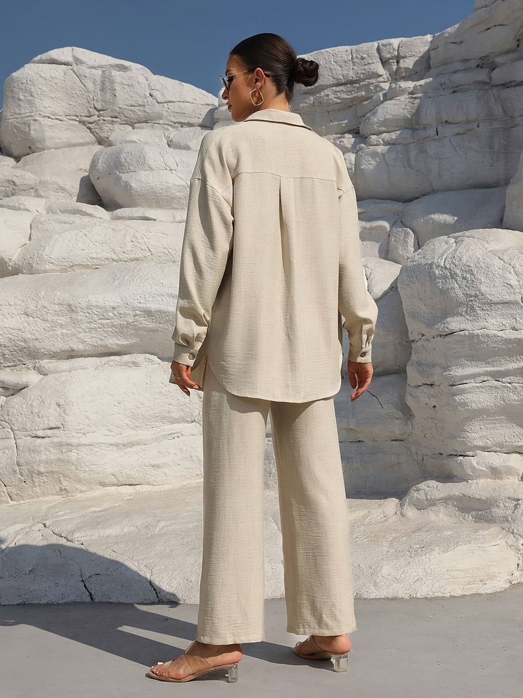 Beige button-up long-sleeve shirt and matching pants set, back view.