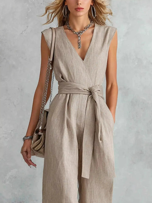 Sleeveless wide-leg jumpsuit in beige linen-look fabric with a waist-wrap belt.