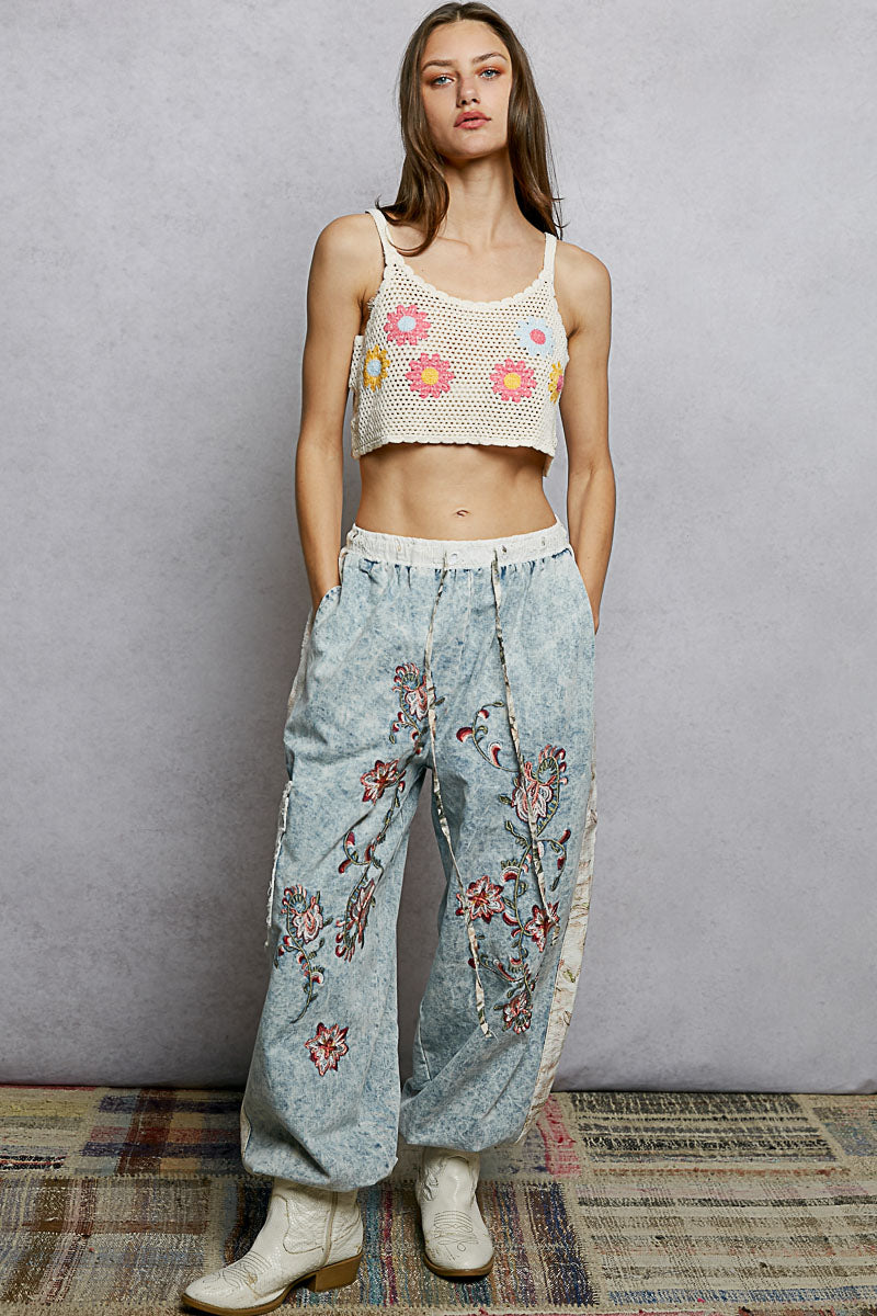 POL U-Neck Cropped Crochet Cami with Floral Embroidery; cream crop top and light-wash denim pants with pink and yellow florals