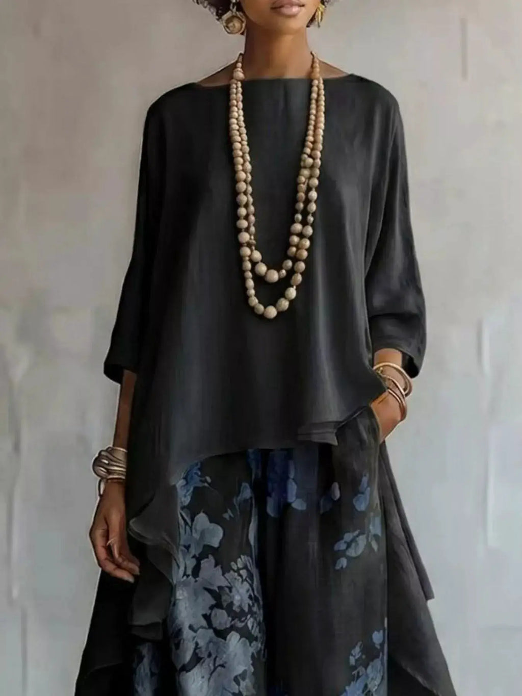 Asymmetrical Hem Top and Floral Pants Set, Belle Bijouix; black top with blue floral pants and layered beige bead necklaces