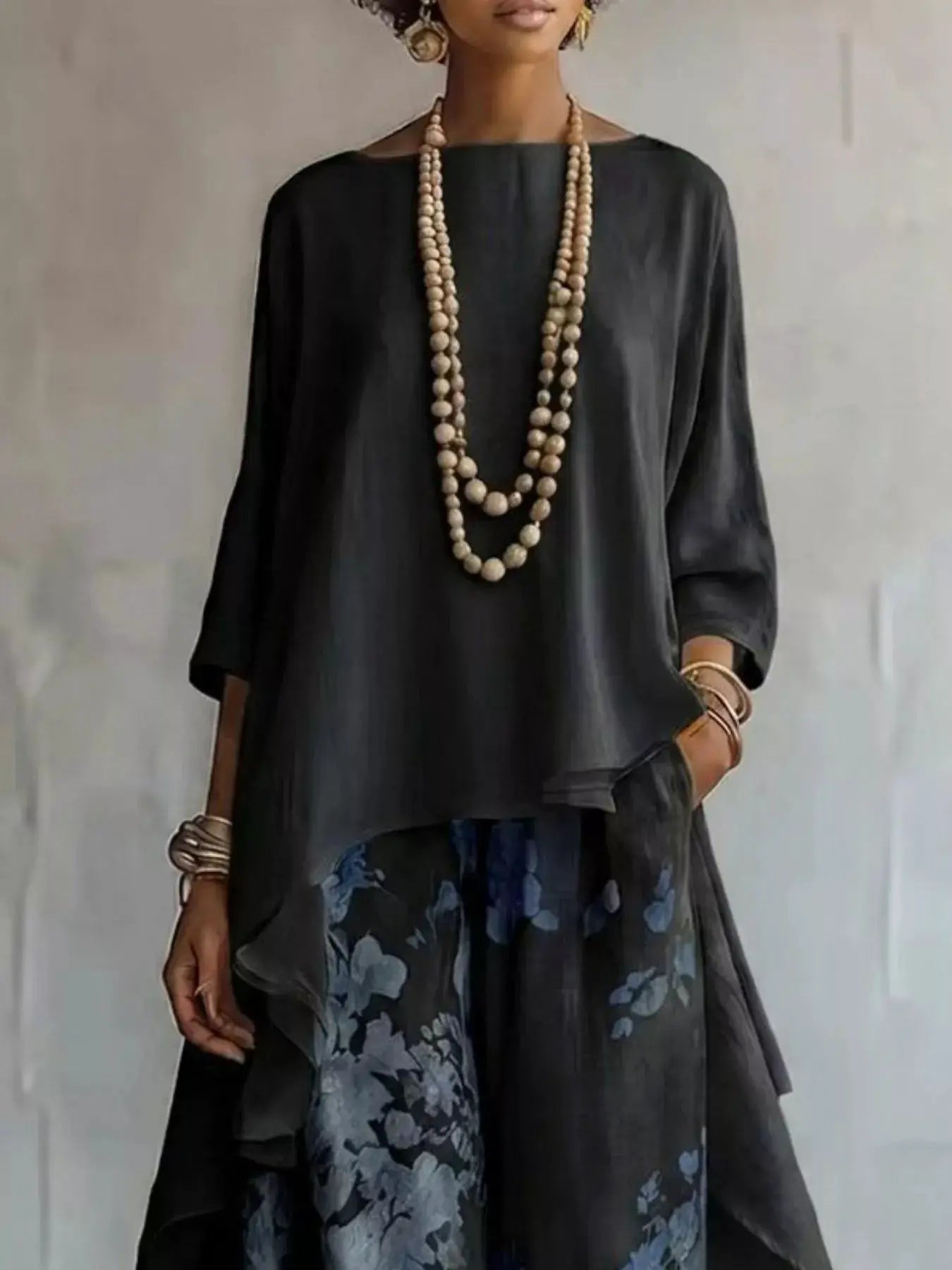 Asymmetrical Hem Top and Floral Pants Set, Belle Bijouix; black top with blue floral pants and layered beige bead necklaces