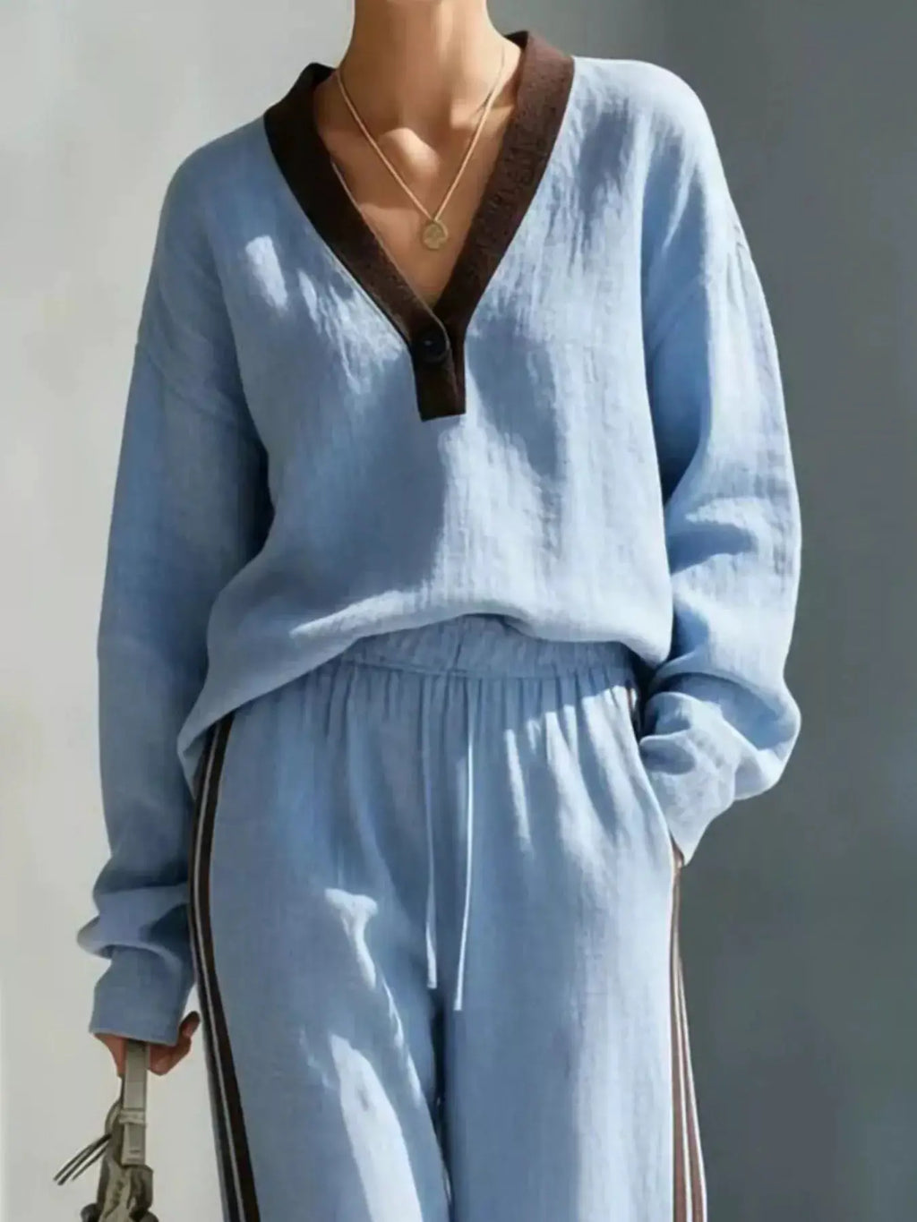 Contrast V-Neck Top and Striped Pants Set by Trendsi in light blue with brown neckline trim.
