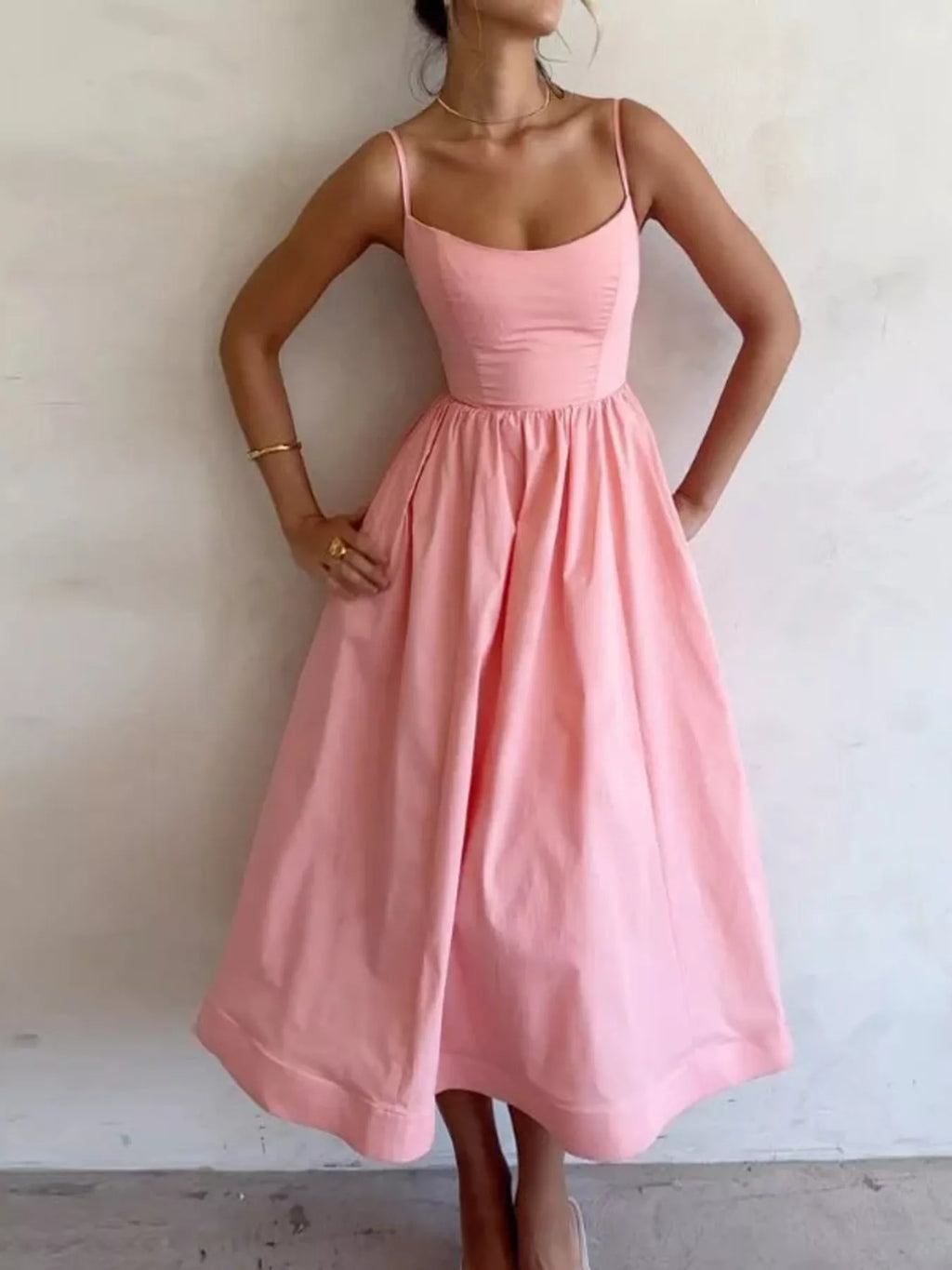 Adjustable-strap scoop-neck pink midi dress with a fitted bodice and an A-line skirt.
