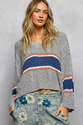 Knit cropped top with V-neck and cable-knit texture; grey base with blue, orange, and white stripes, long sleeves