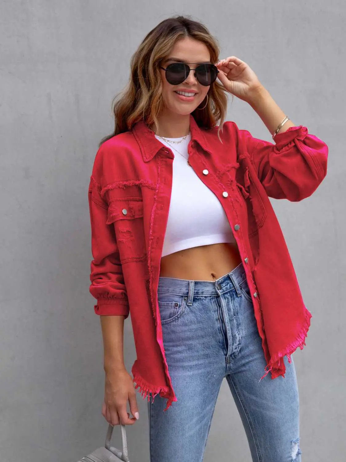 Distressed Drop-Shoulder Denim Jacket in red with frayed hems, worn over a white crop top