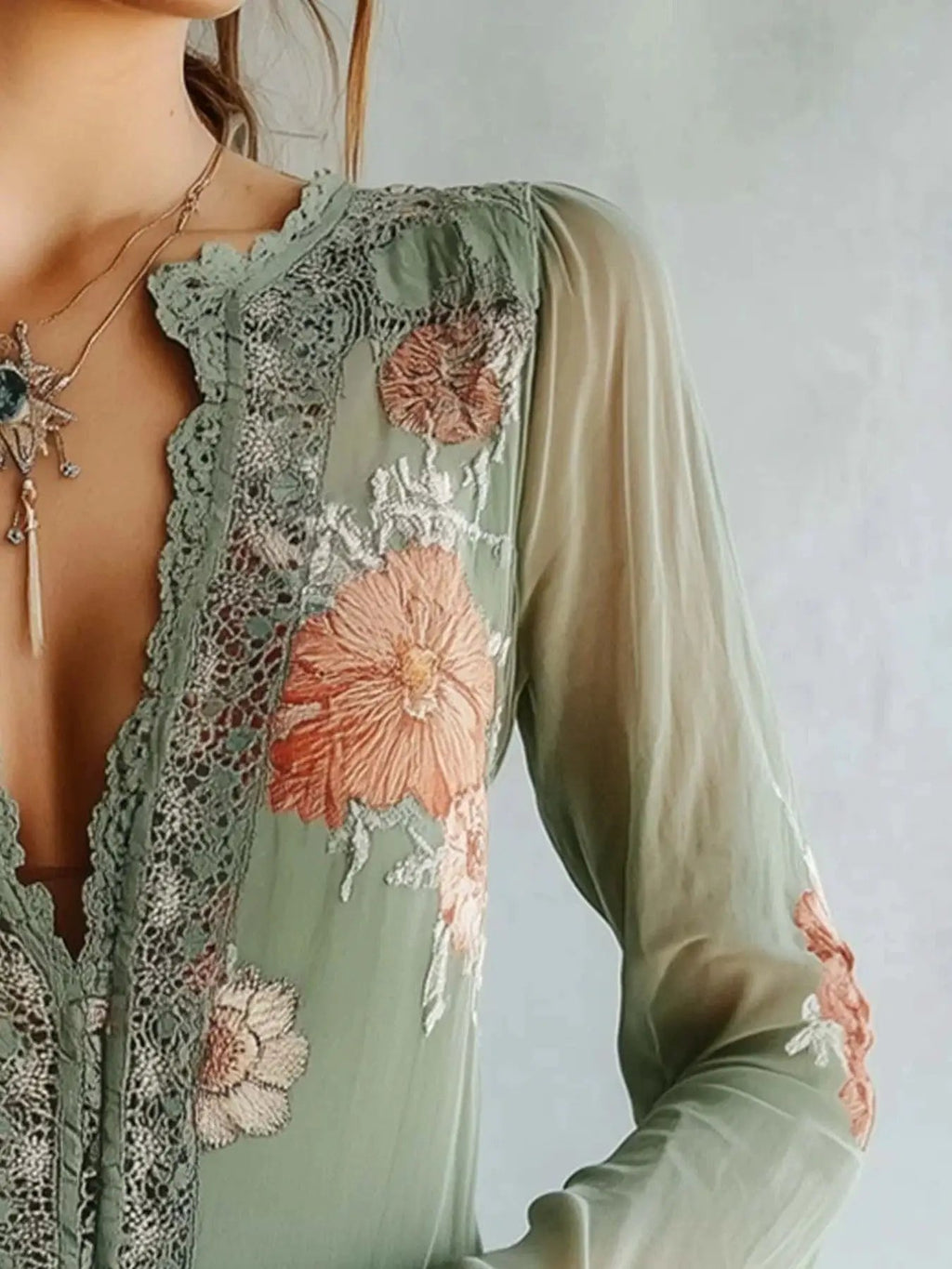 Lace-detail floral blouse in sage green with pink embroidery and sheer sleeves