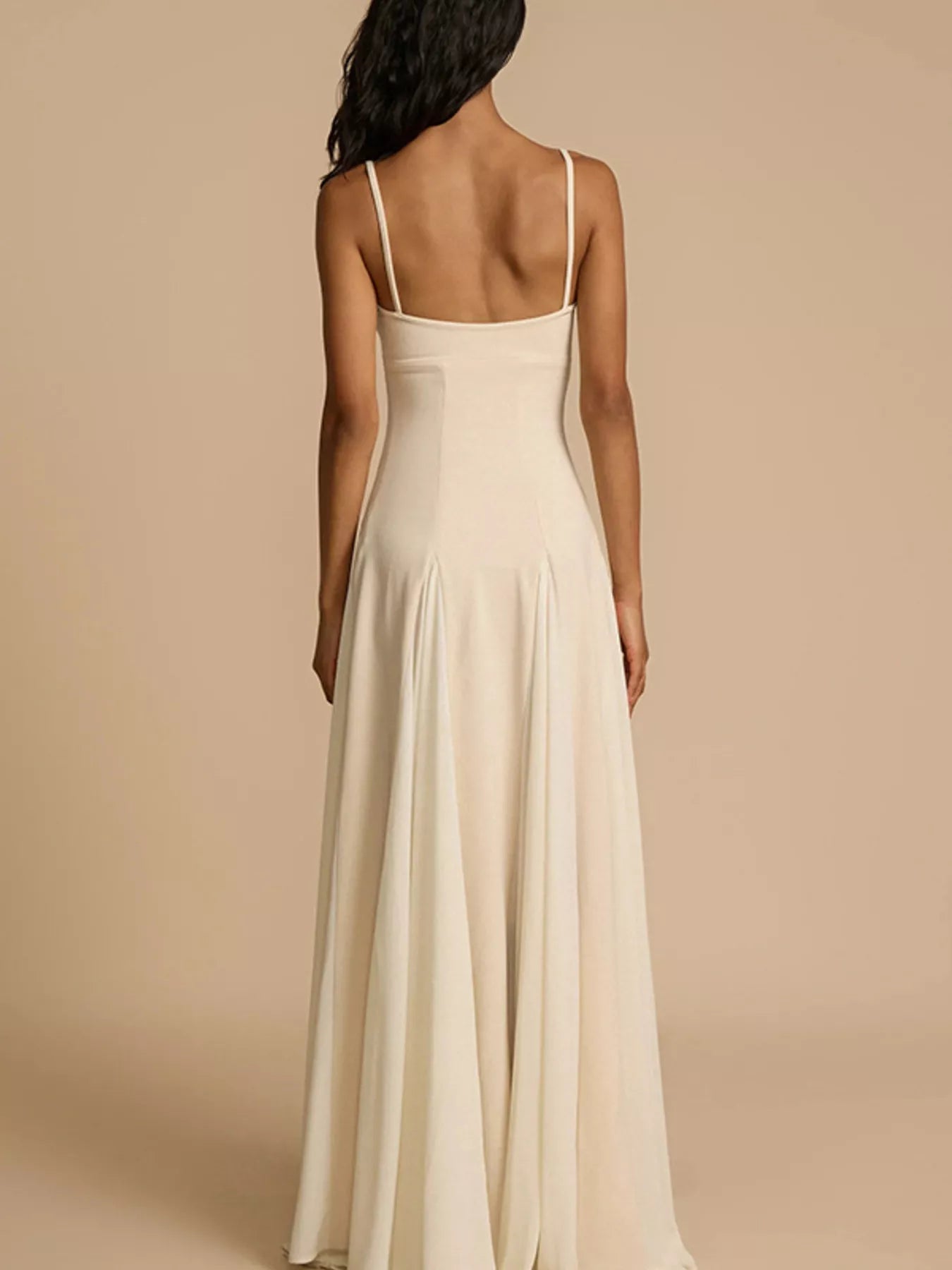 Sweetheart neck spaghetti-strap cream maxi dress with flowing skirt, back view.