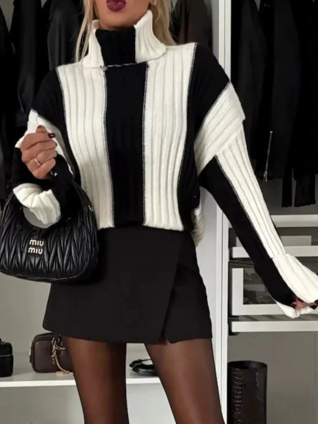 Color Block Ribbed Turtleneck Sweater by Belle Bijouix in black and white, paired with a Miu Miu quilted bag.