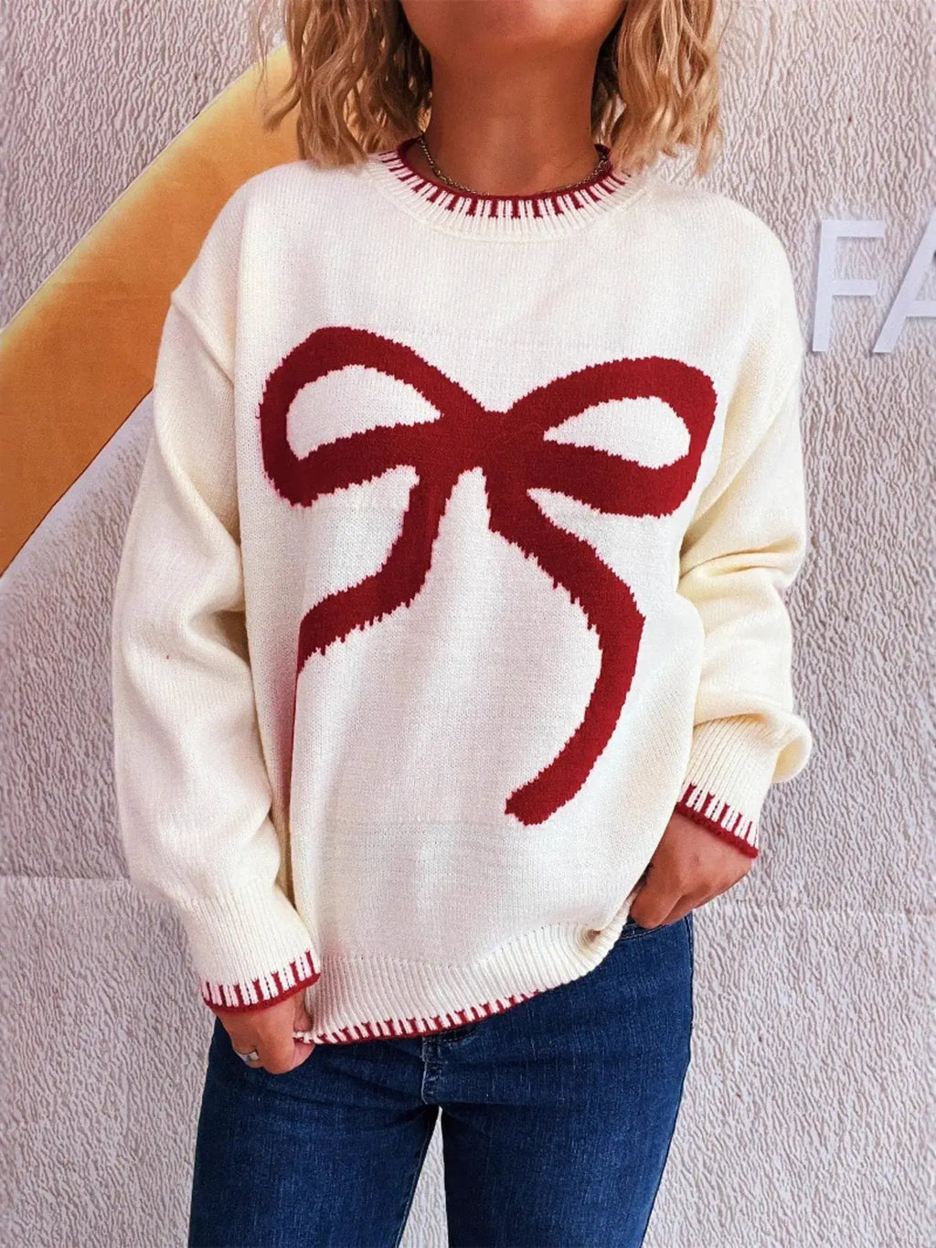 Bow Pattern Round Neck Sweater, white knit with a large red bow graphic, long sleeves.