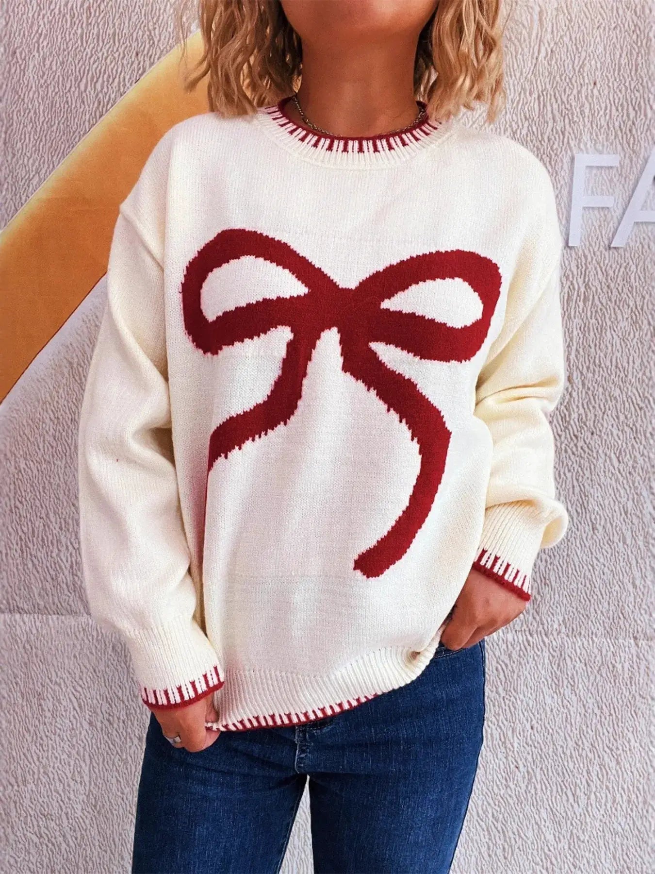 Bow Pattern Round Neck Sweater, white knit with a large red bow graphic, long sleeves.