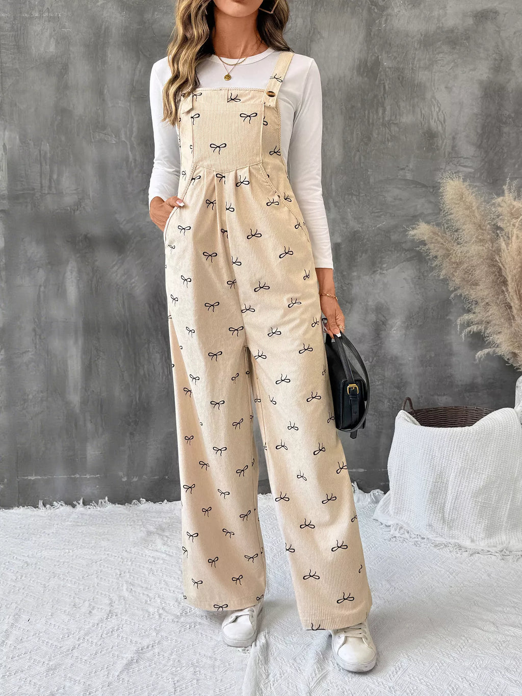 Bow Wide Leg Corduroy Overalls by Belle Bijouix in beige corduroy with tiny bow print and pockets.