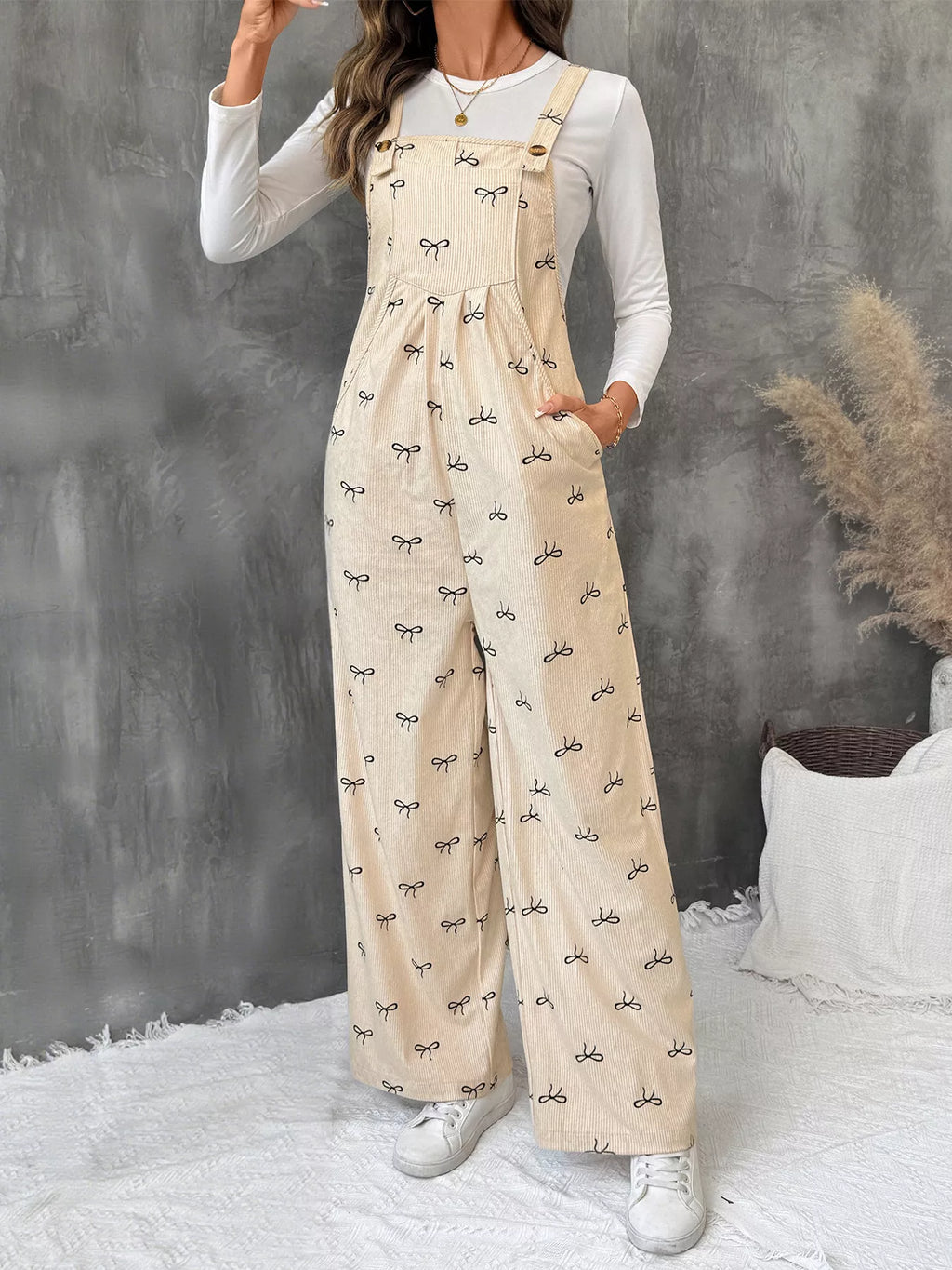 Belle Bijouix Bow Wide Leg Corduroy Overalls in beige with black bow pattern and pockets