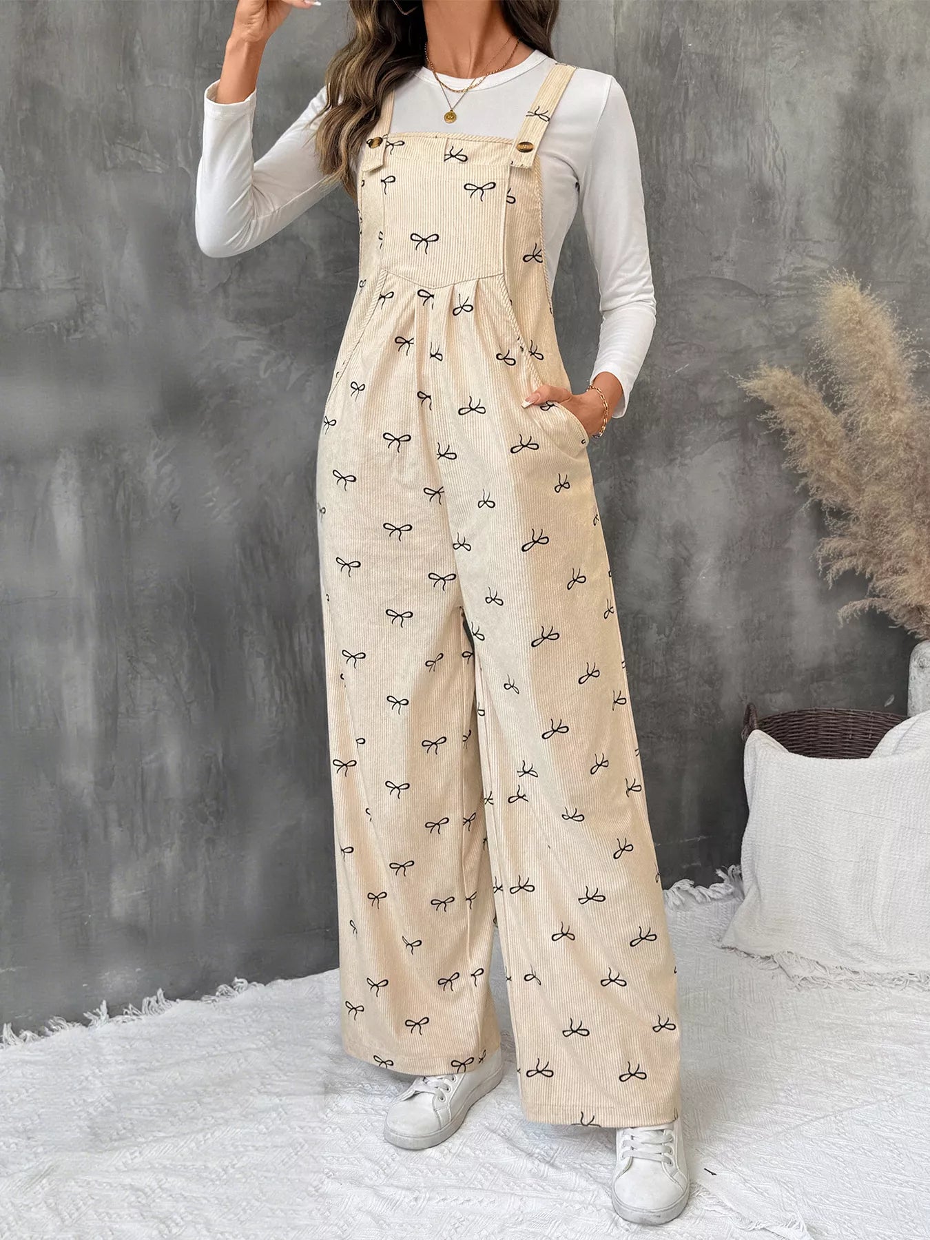 Belle Bijouix Bow Wide Leg Corduroy Overalls in beige with black bow pattern and pockets