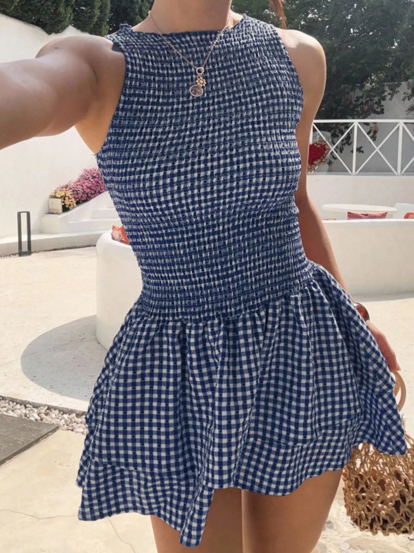 Gingham smocked mini dress in navy and white, sleeveless with gathered waist and full skirt