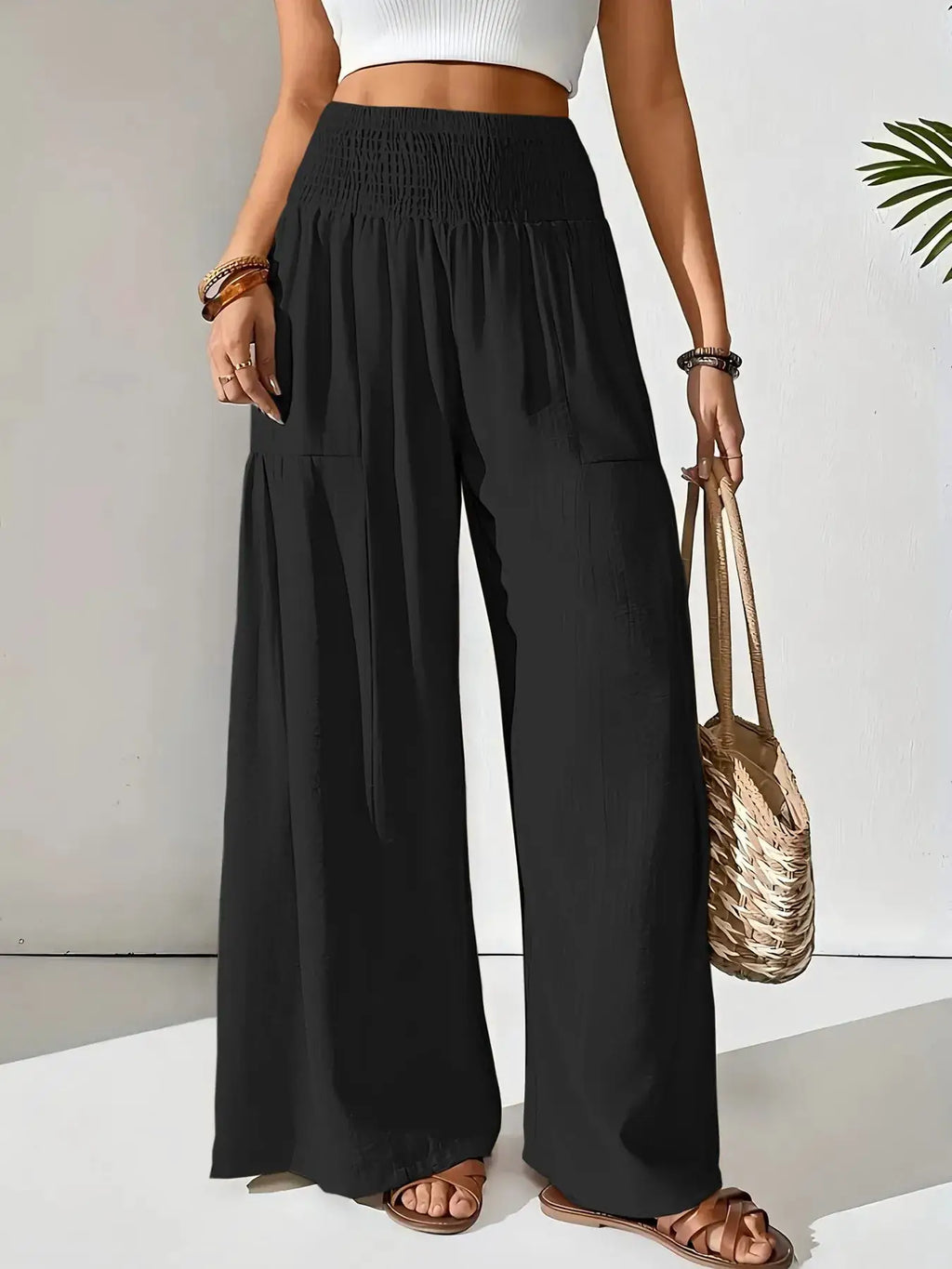 Smocked Waist Wide Leg Pants, black pocketed bottoms with a smocked waistband.
