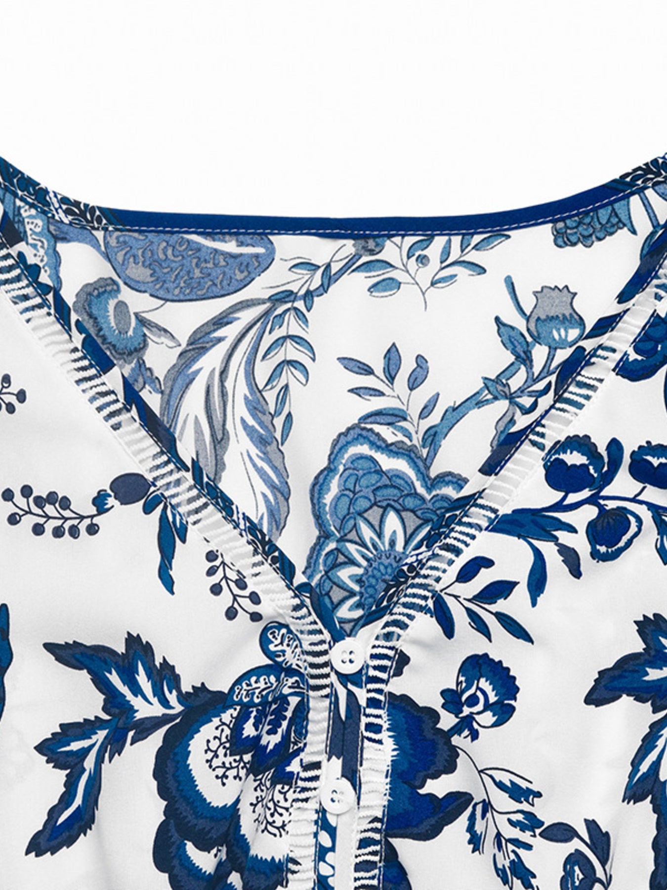 Floral print sleeveless V-neck midi dress, blue-and-white pattern, buttoned front with belted waist.