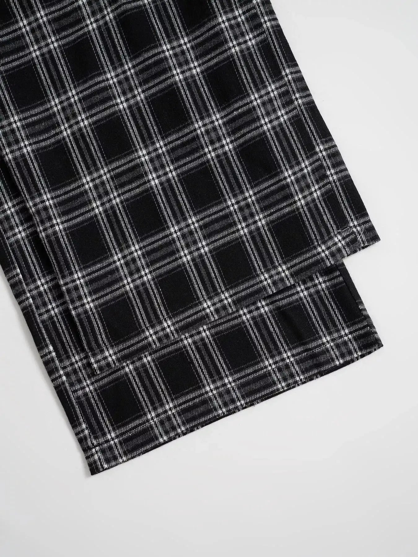 Relaxed Fit Plaid Pants in black-and-white check, close-up hem view