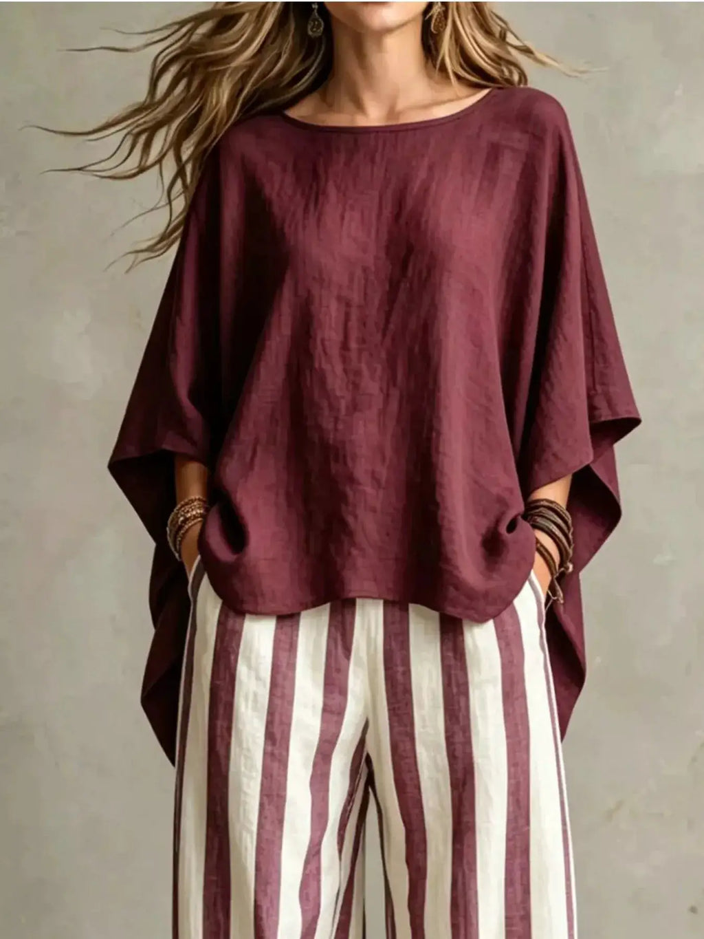 Plus-size two-piece outfit set with burgundy solid top featuring batwing sleeves and burgundy/white striped pants