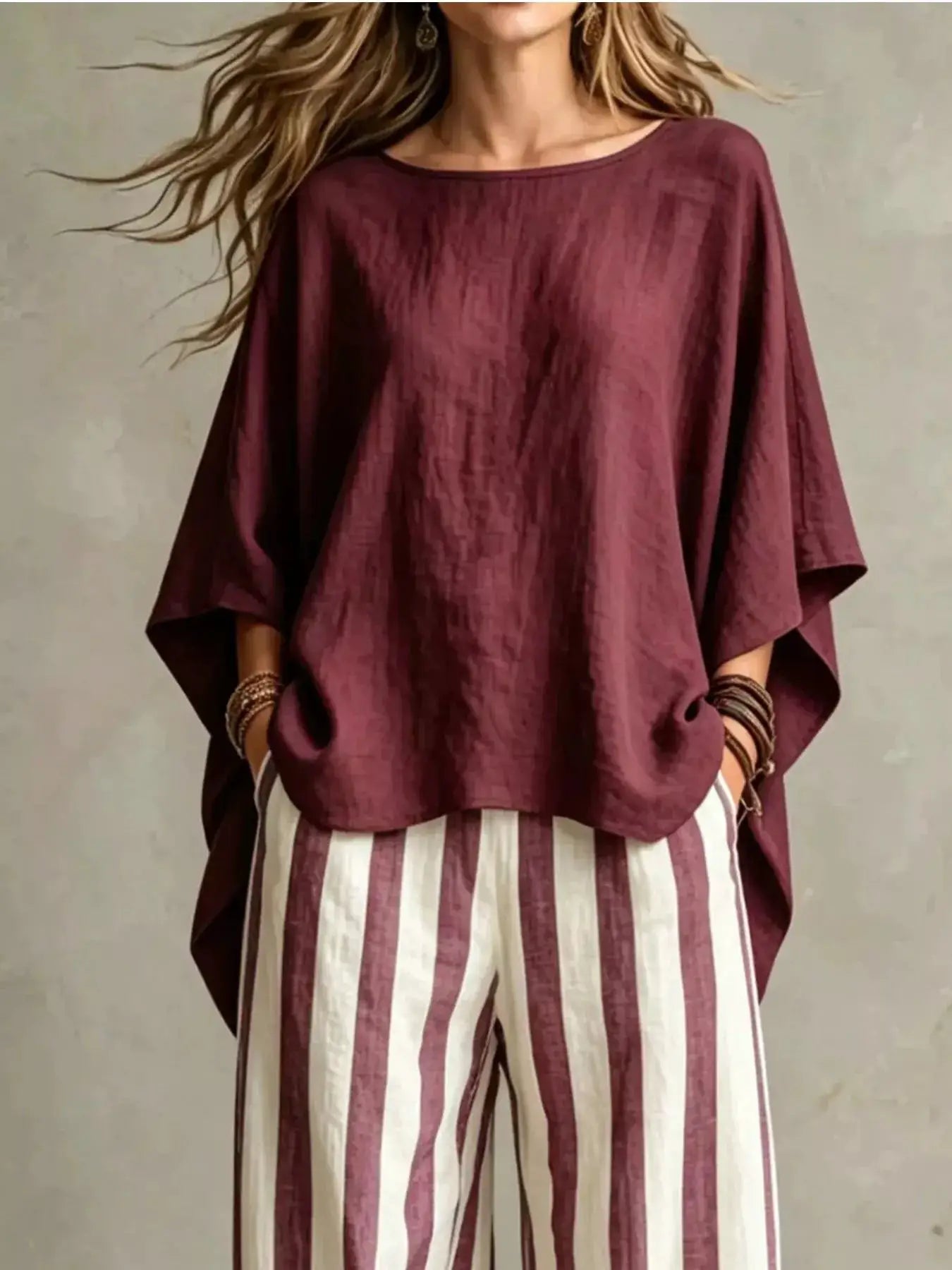 Plus-size two-piece outfit set with burgundy solid top featuring batwing sleeves and burgundy/white striped pants