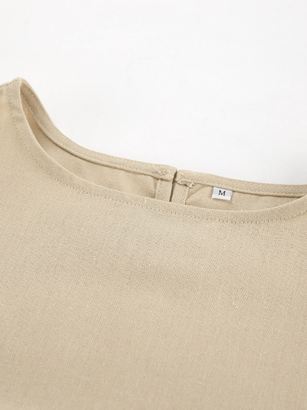 Sleeveless crop top and slit pants set in beige linen-like fabric, size M.
