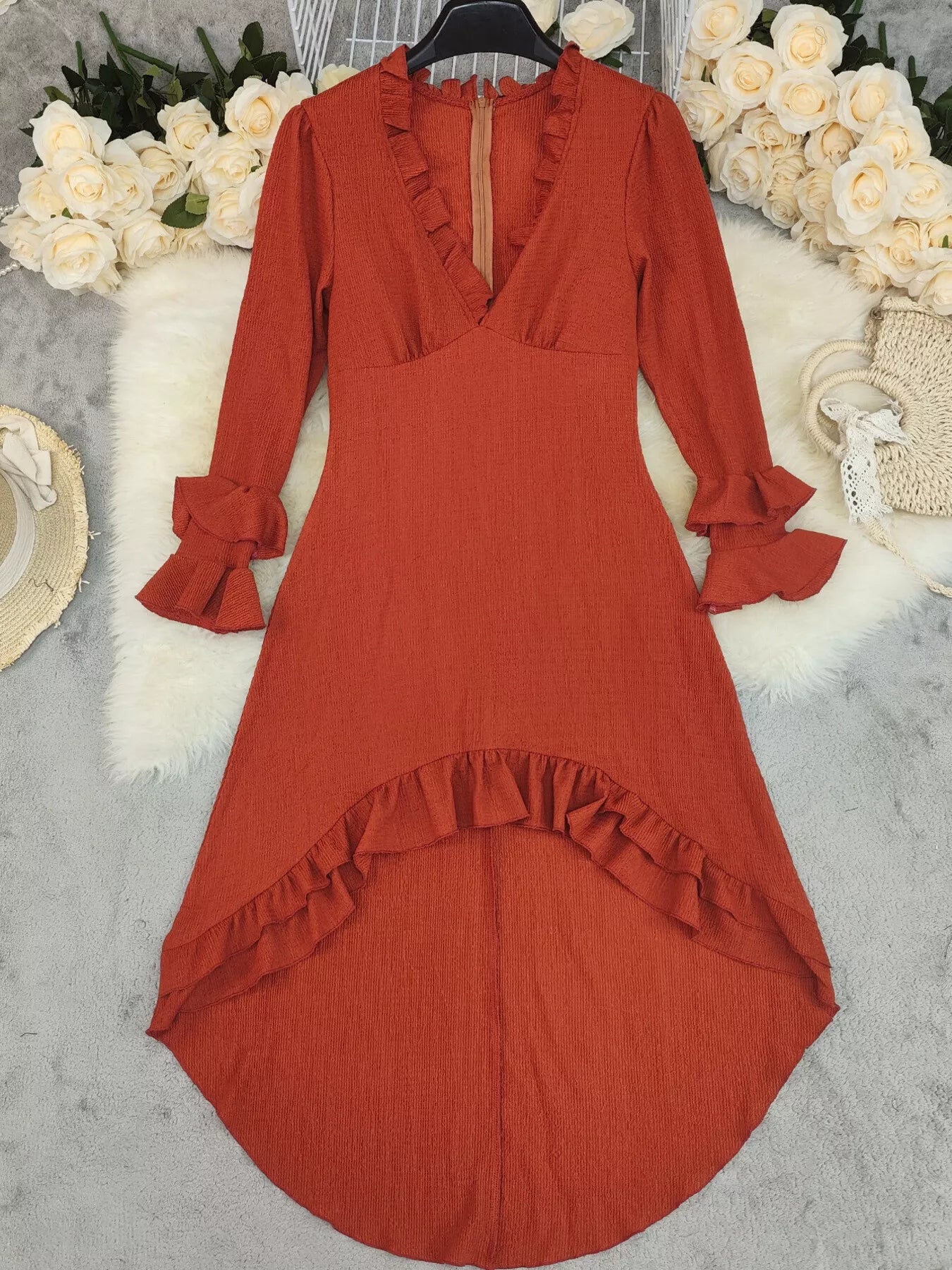 Ruffled High-Low Long Sleeve Dress by Belle Bijouix in rust-red textured fabric.