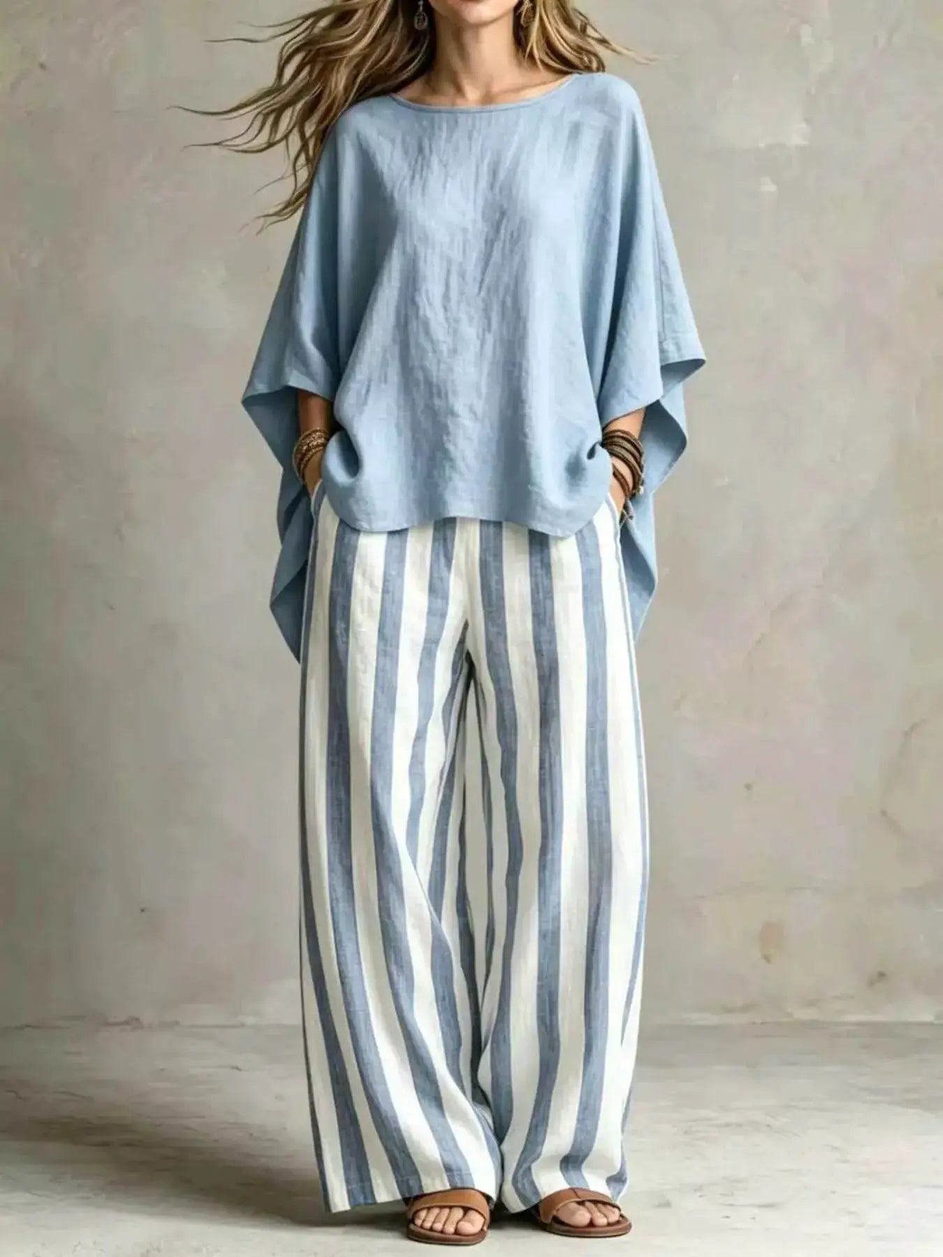 Outfit set by Belle Bijouix: plus-size light-blue oversized top with blue-and-white striped wide-leg pants.