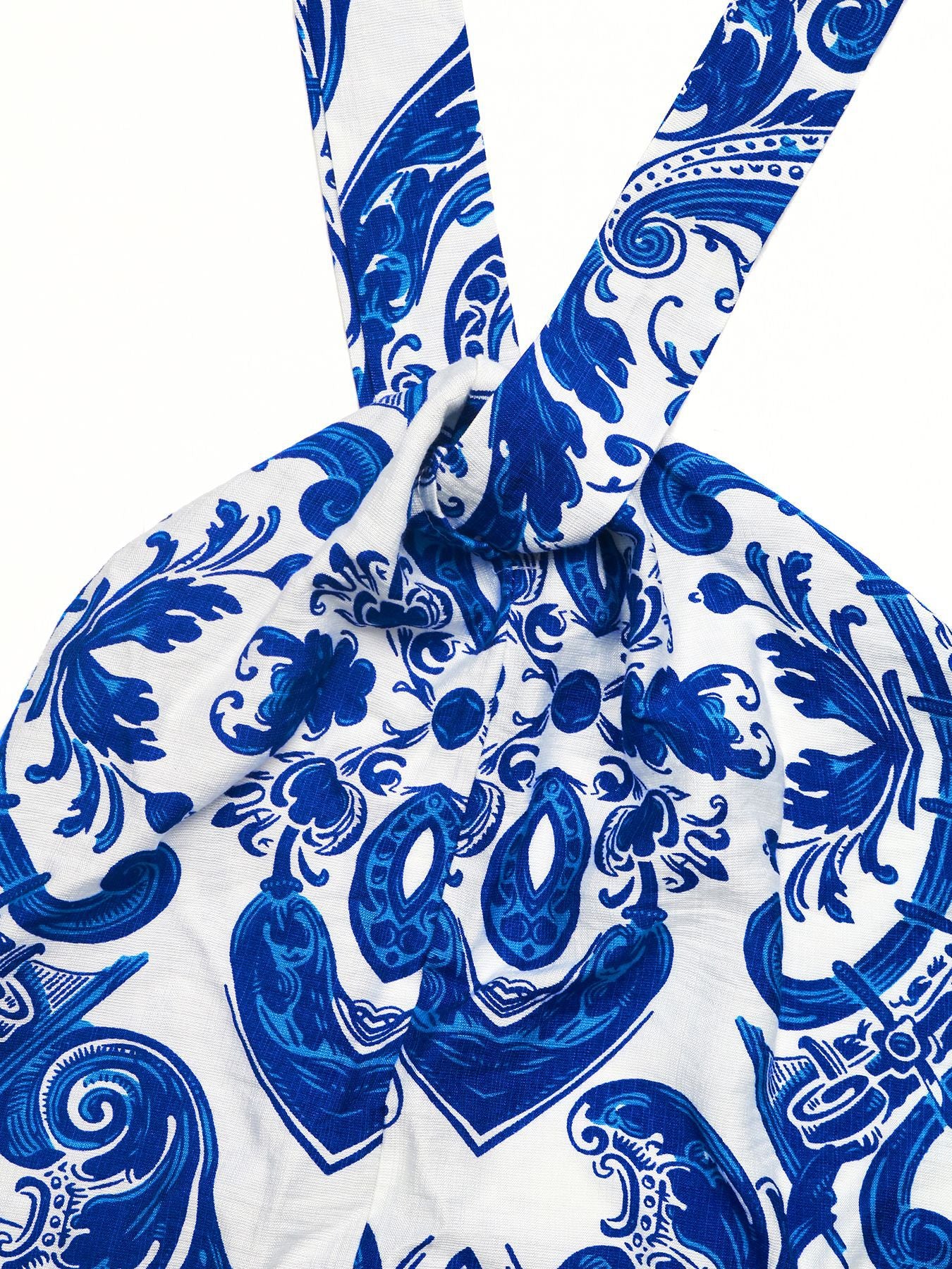 Printed halter neck maxi dress with blue and white pattern and front knot detail