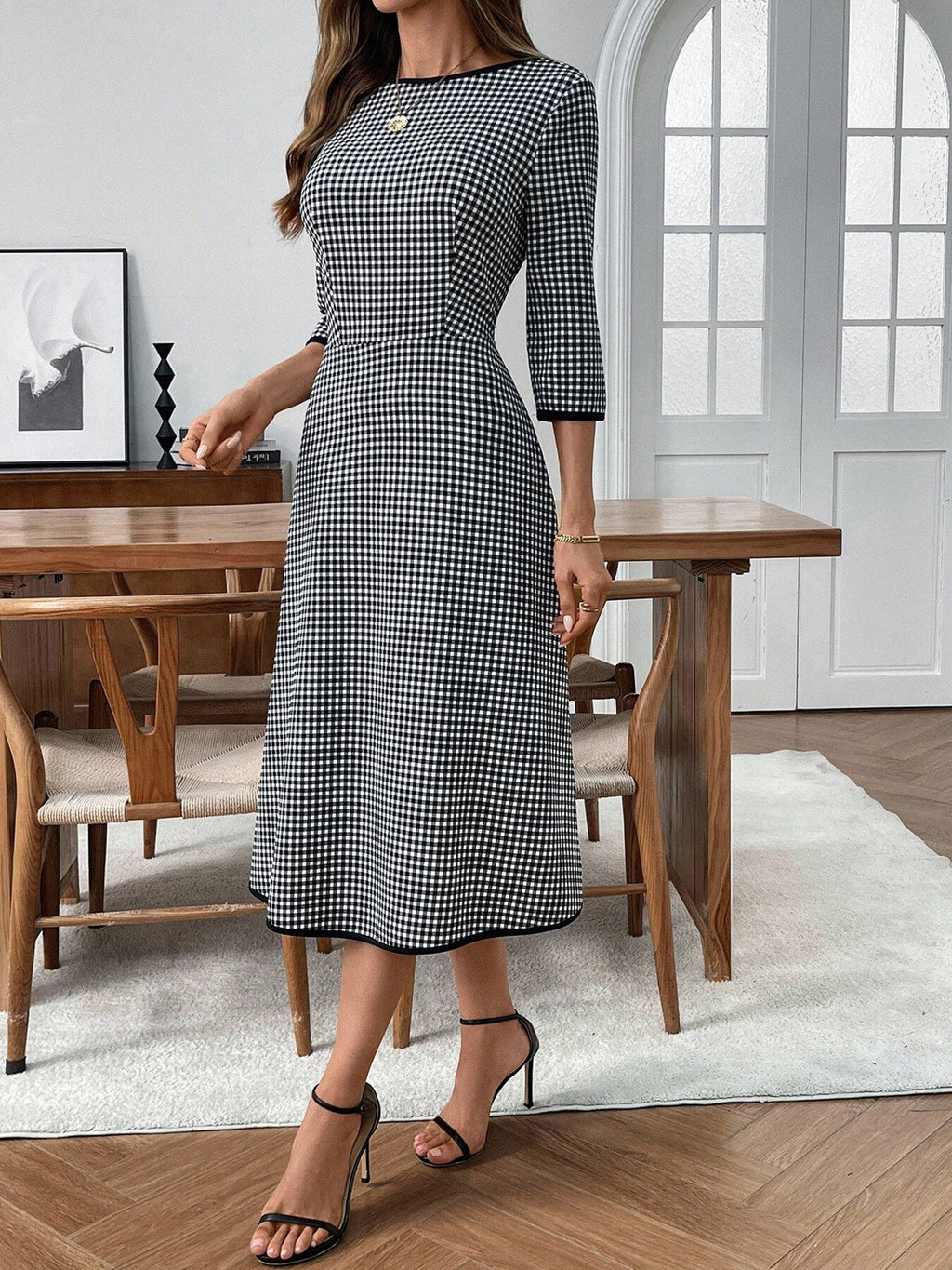 Plaid round-neck 3/4 sleeve dress in black-and-white gingham, midi length.