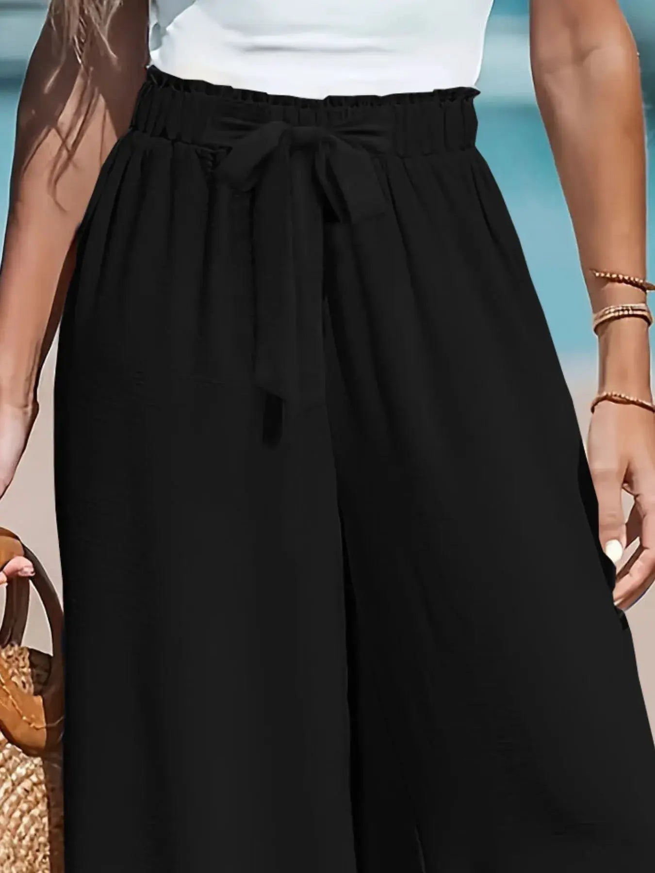 Full Size Drawstring Waist Wide Leg Pants in black with a tied waist detail