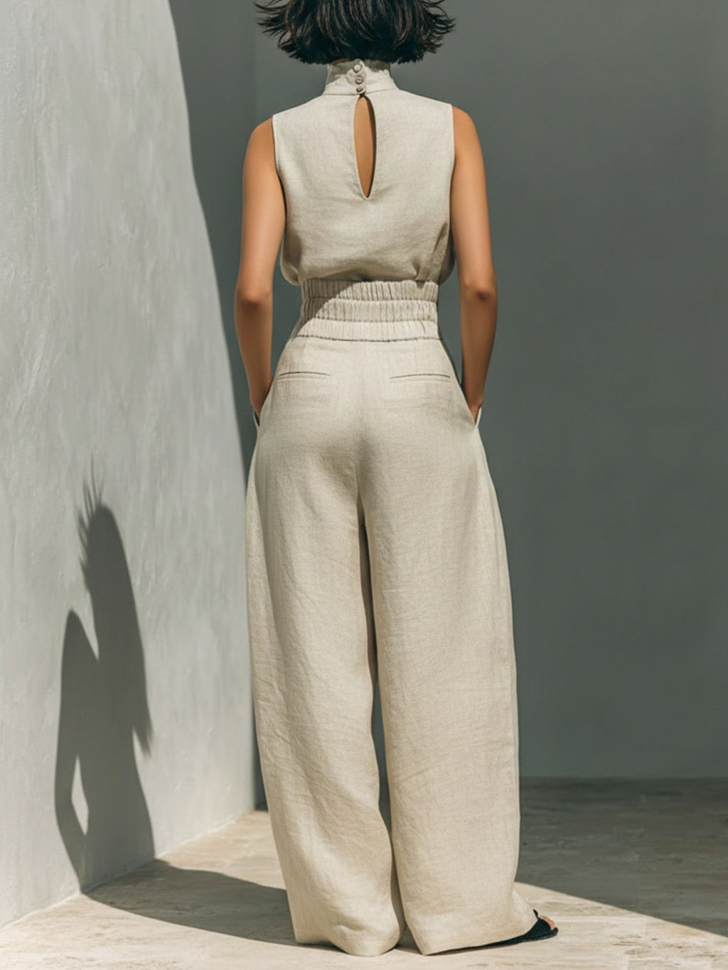 Turtleneck sleeveless top and pants set in cream linen, back view, 2-piece.