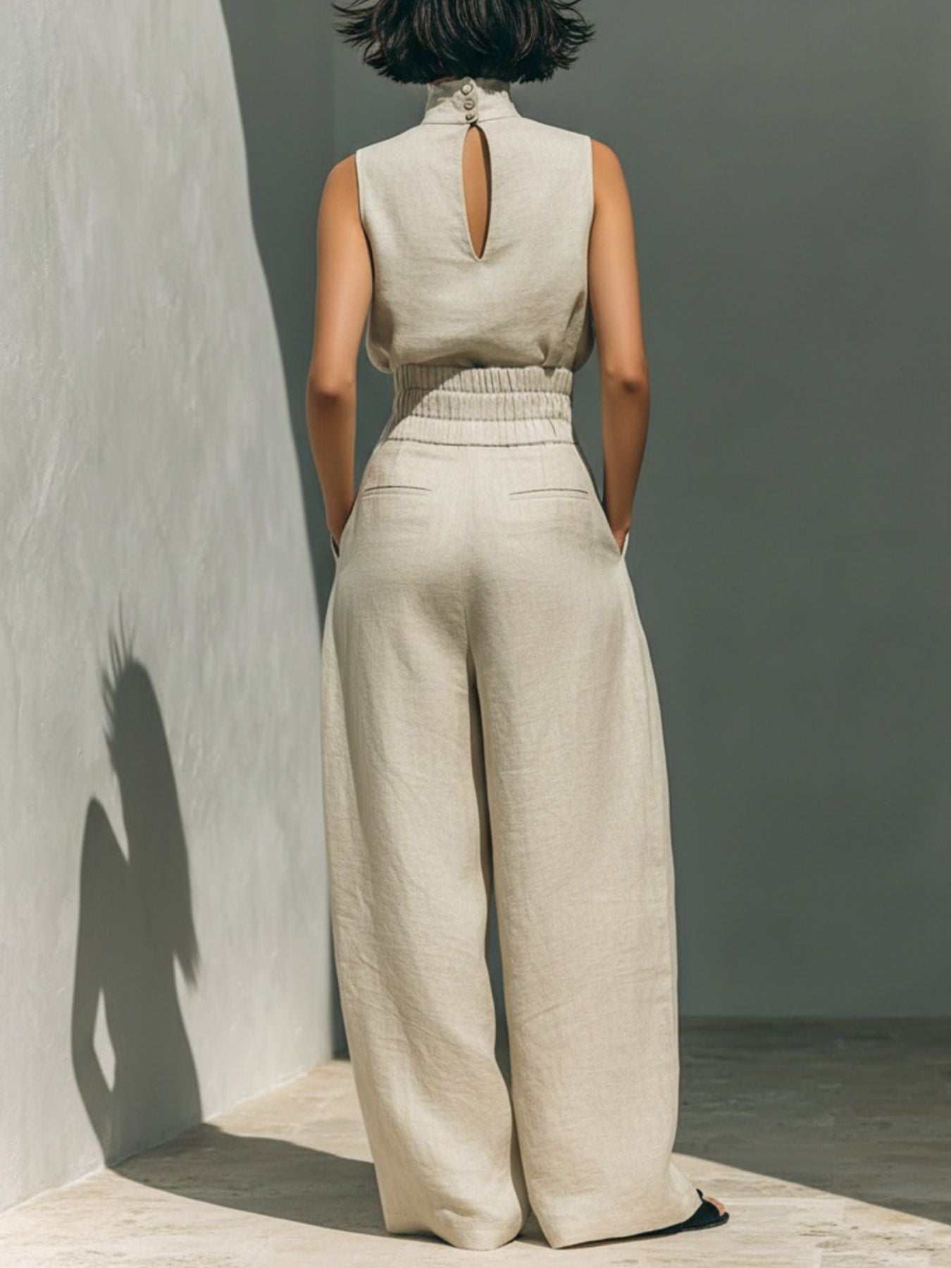 Turtleneck sleeveless top and pants set in cream linen, back view, 2-piece.