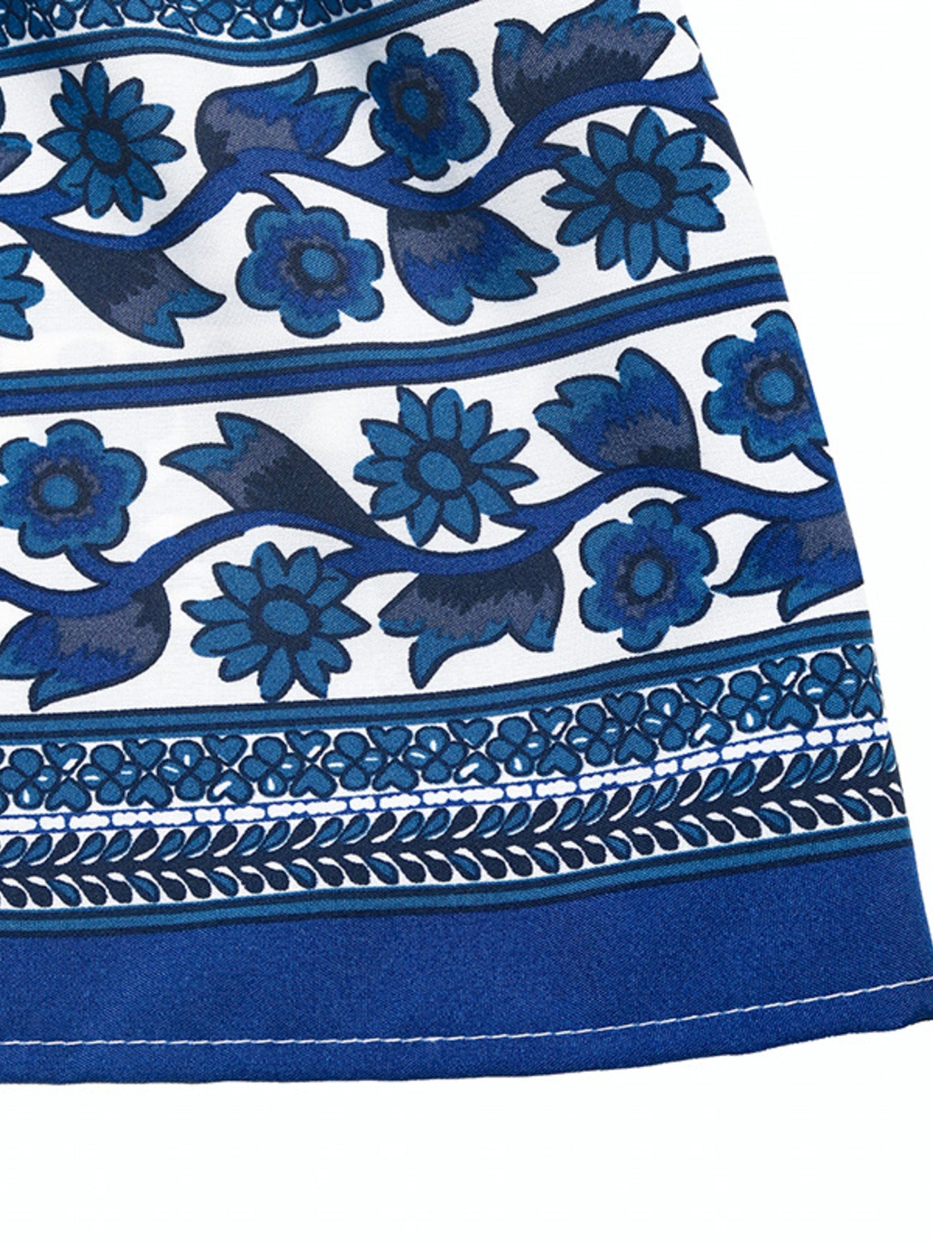 Floral print sleeveless V-neck midi dress in blue on white with decorative border trim