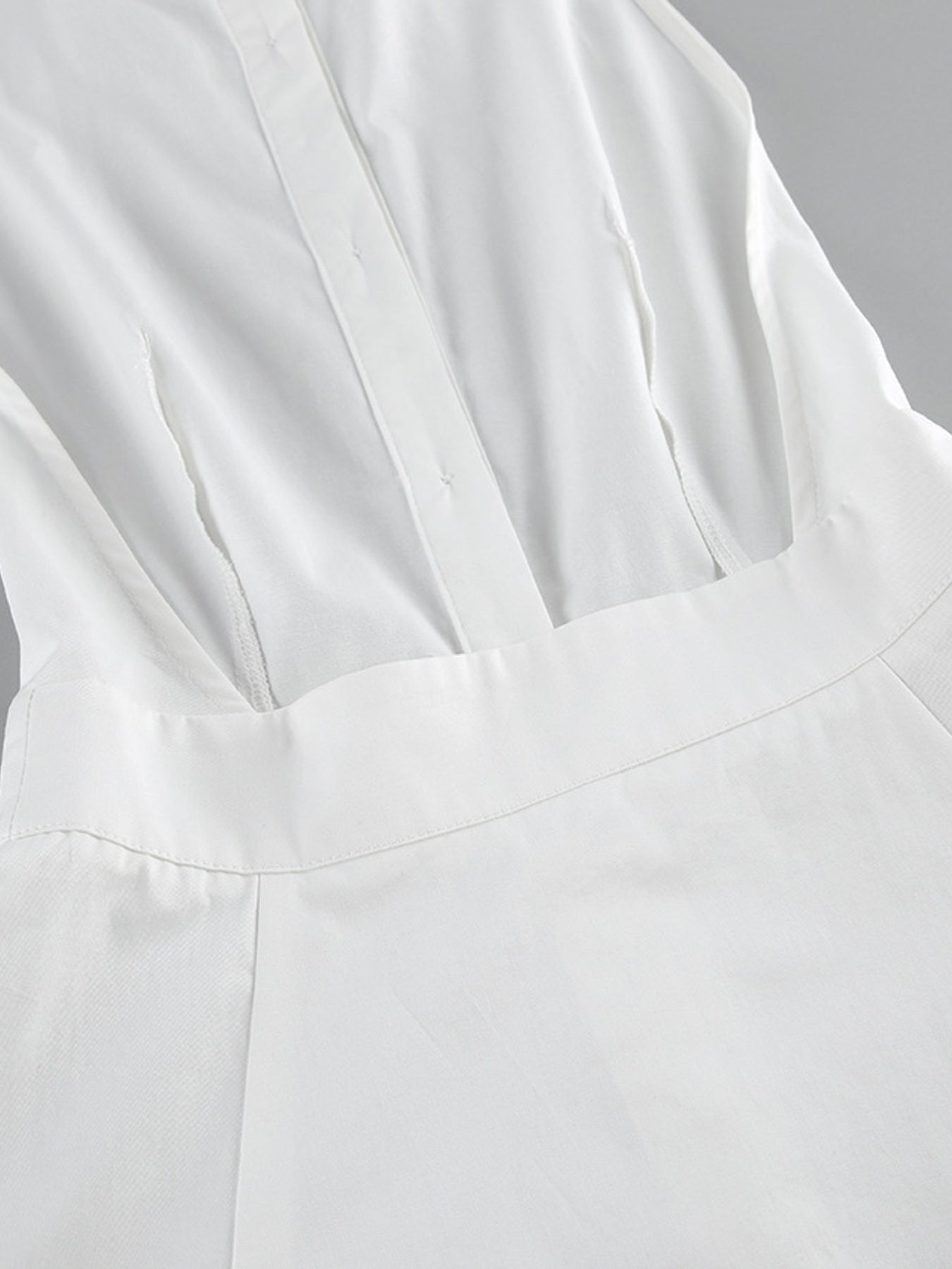 Backless sleeveless button-front maxi dress in white by Belle Bijouix