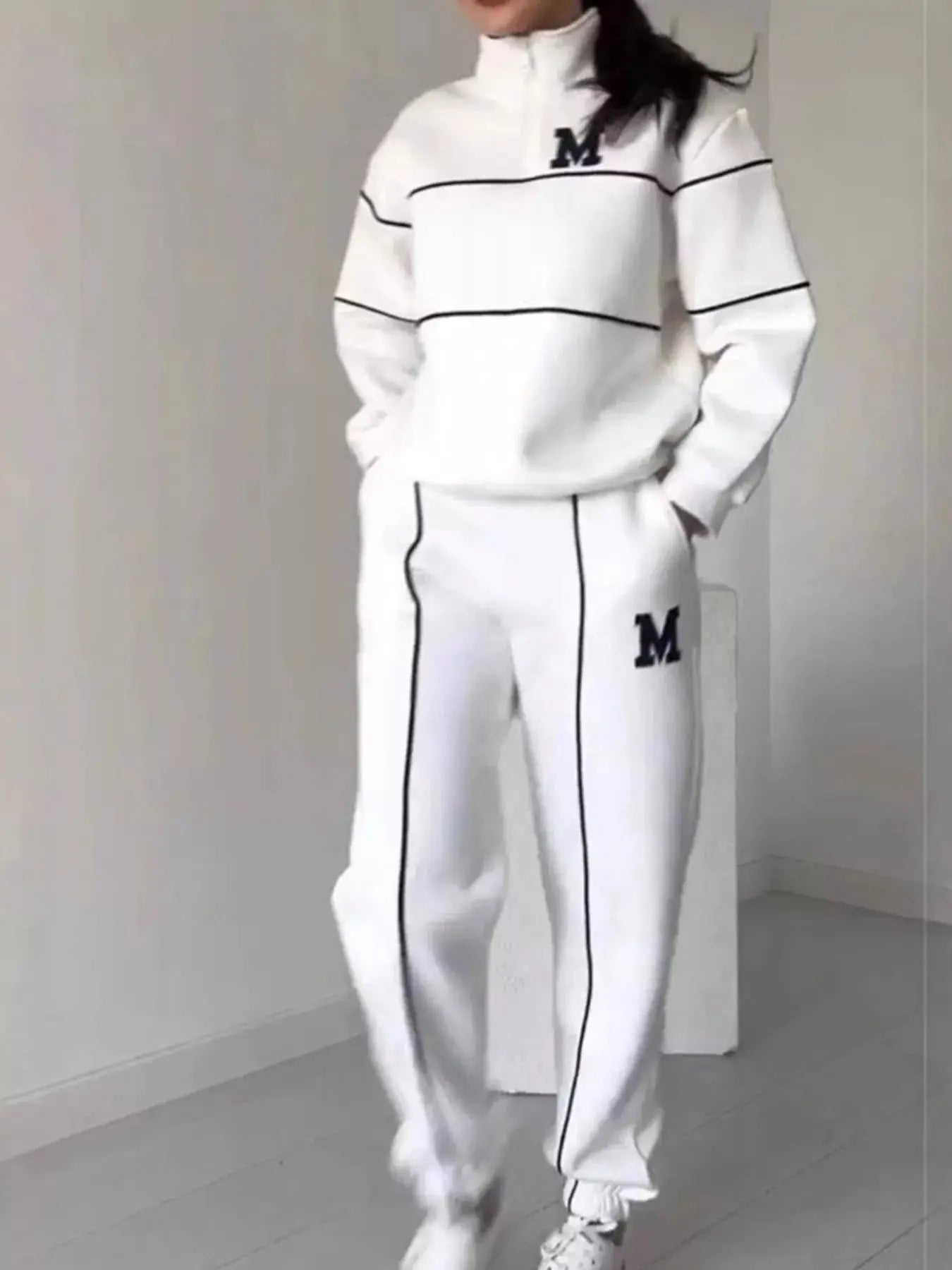 Plus-size white striped loungewear set with black piping; quarter-zip top and matching pants