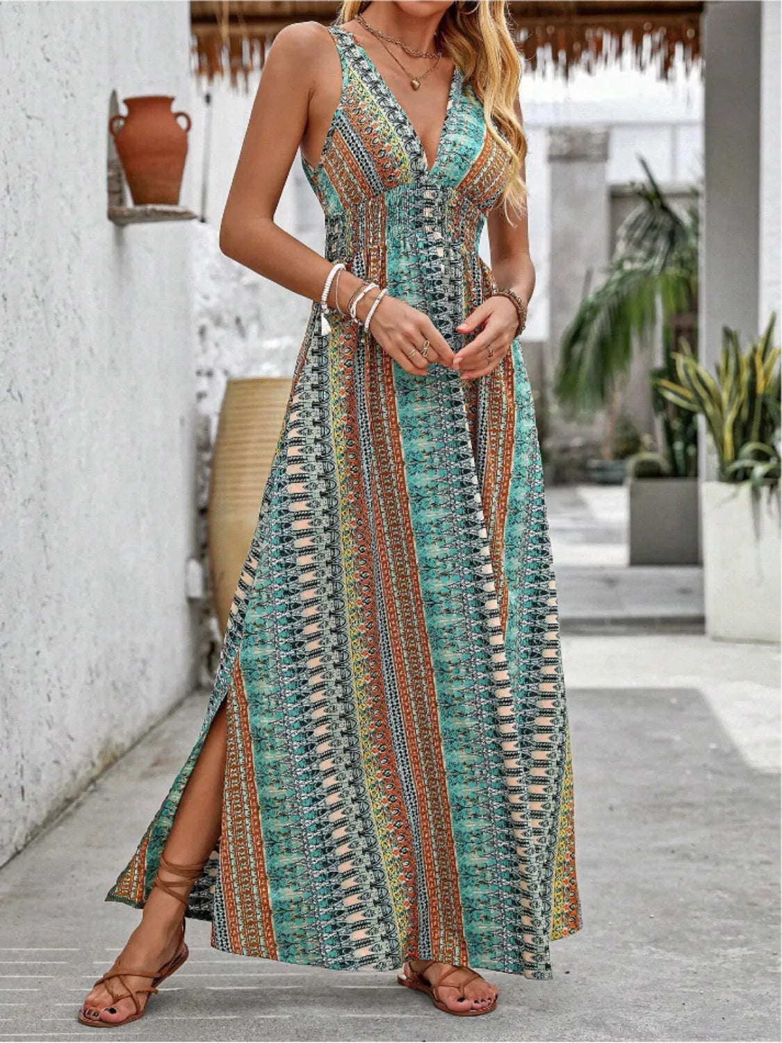 Tied Back Printed Sleeveless Maxi Slit Dress in teal, orange, and ivory pattern with V-neck and side slit