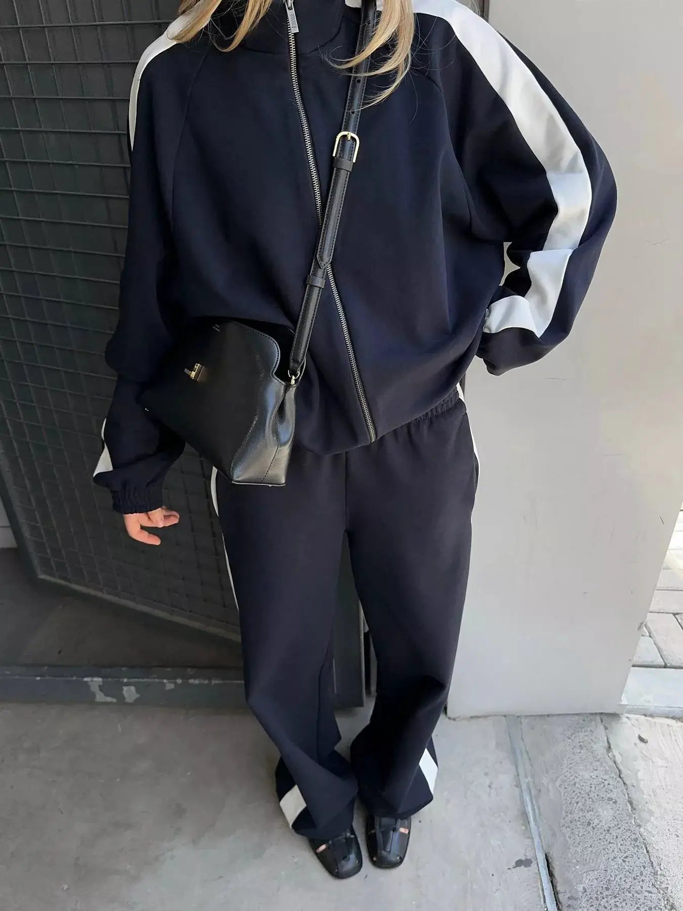 Two-Piece zip-up long sleeve activewear set with jacket and pants in navy featuring white stripe side panels