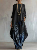 Asymmetrical Hem Top and Floral Pants Set by Belle Bijouix; black top with flowy silhouette and blue floral pants.