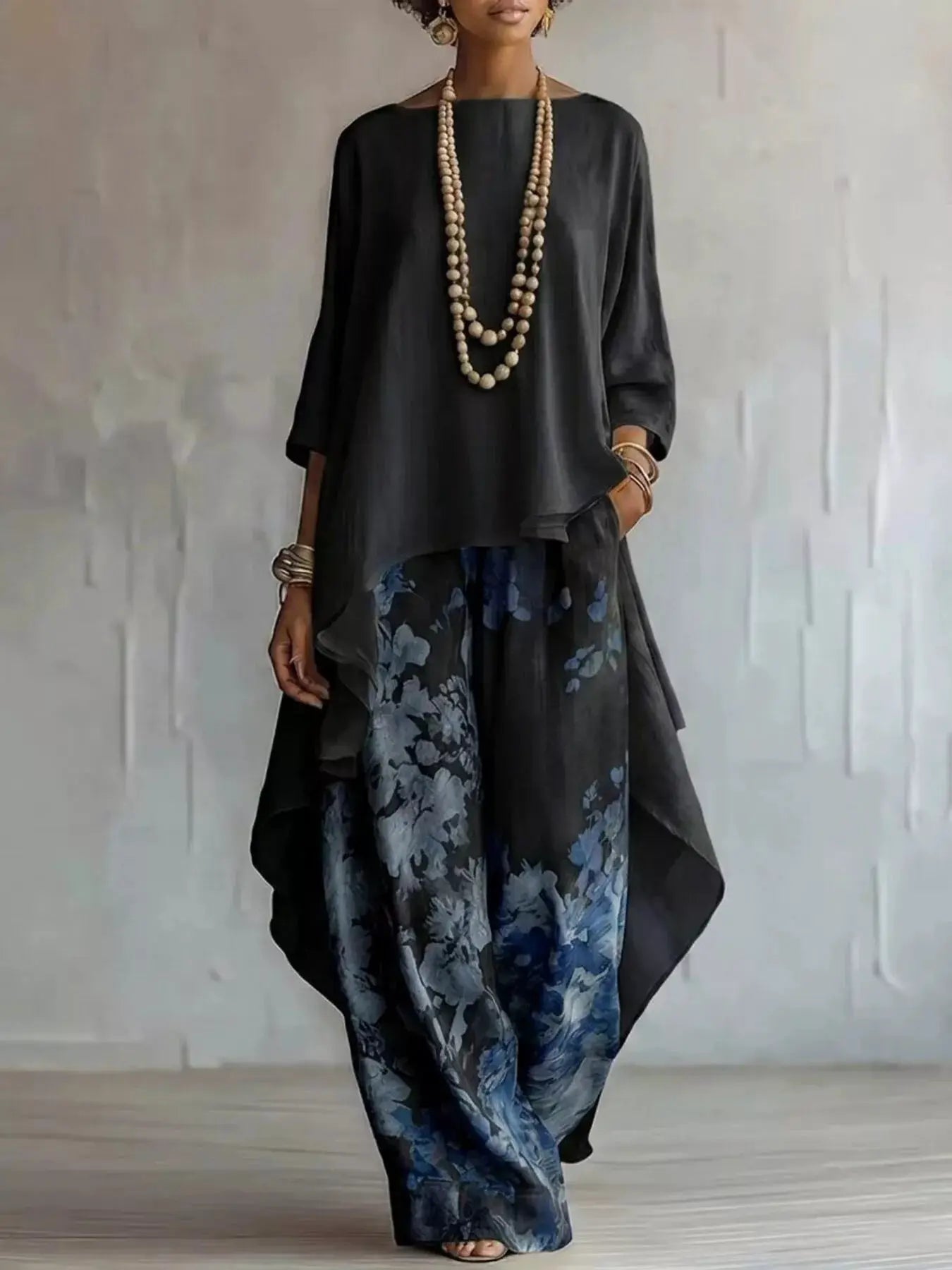 Asymmetrical Hem Top and Floral Pants Set by Belle Bijouix; black top with flowy silhouette and blue floral pants.