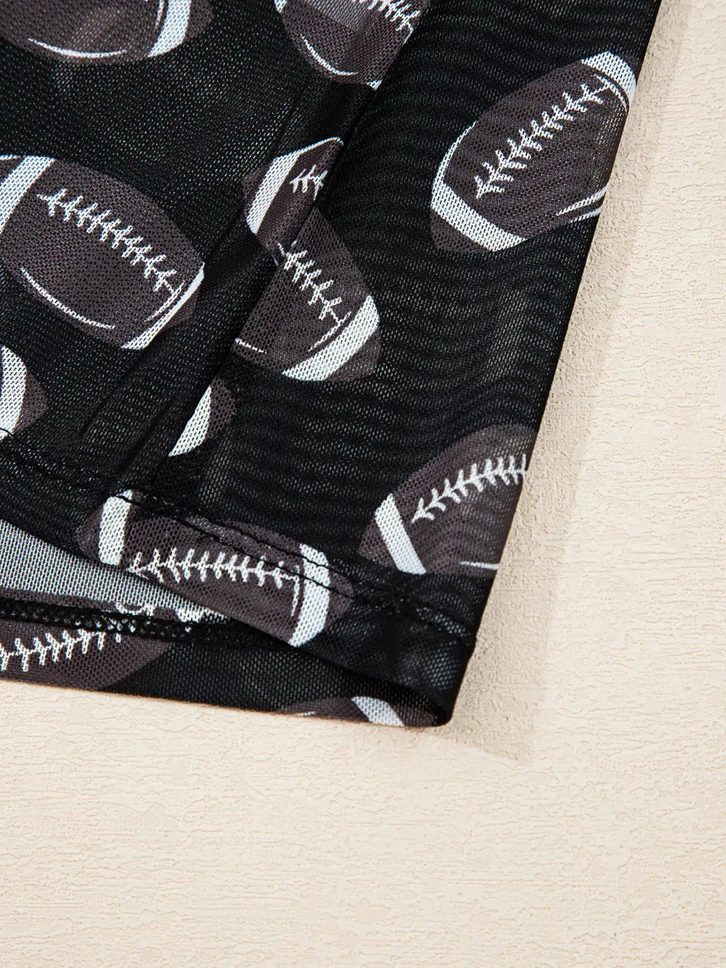 Game Day Mesh Sheer Long Sleeve Top in black mesh with football pattern