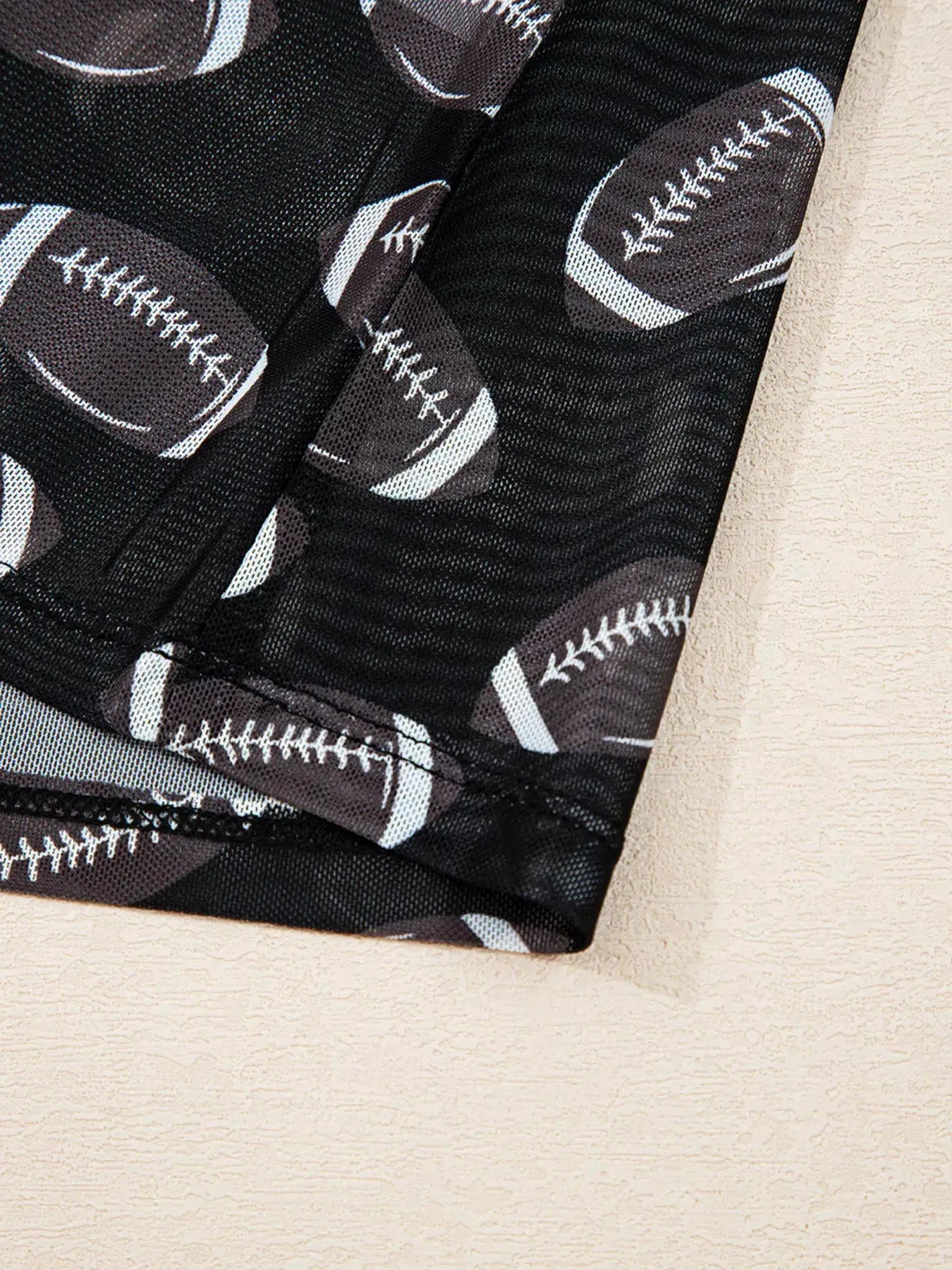 Game Day Mesh Sheer Long Sleeve Top in black mesh with football pattern