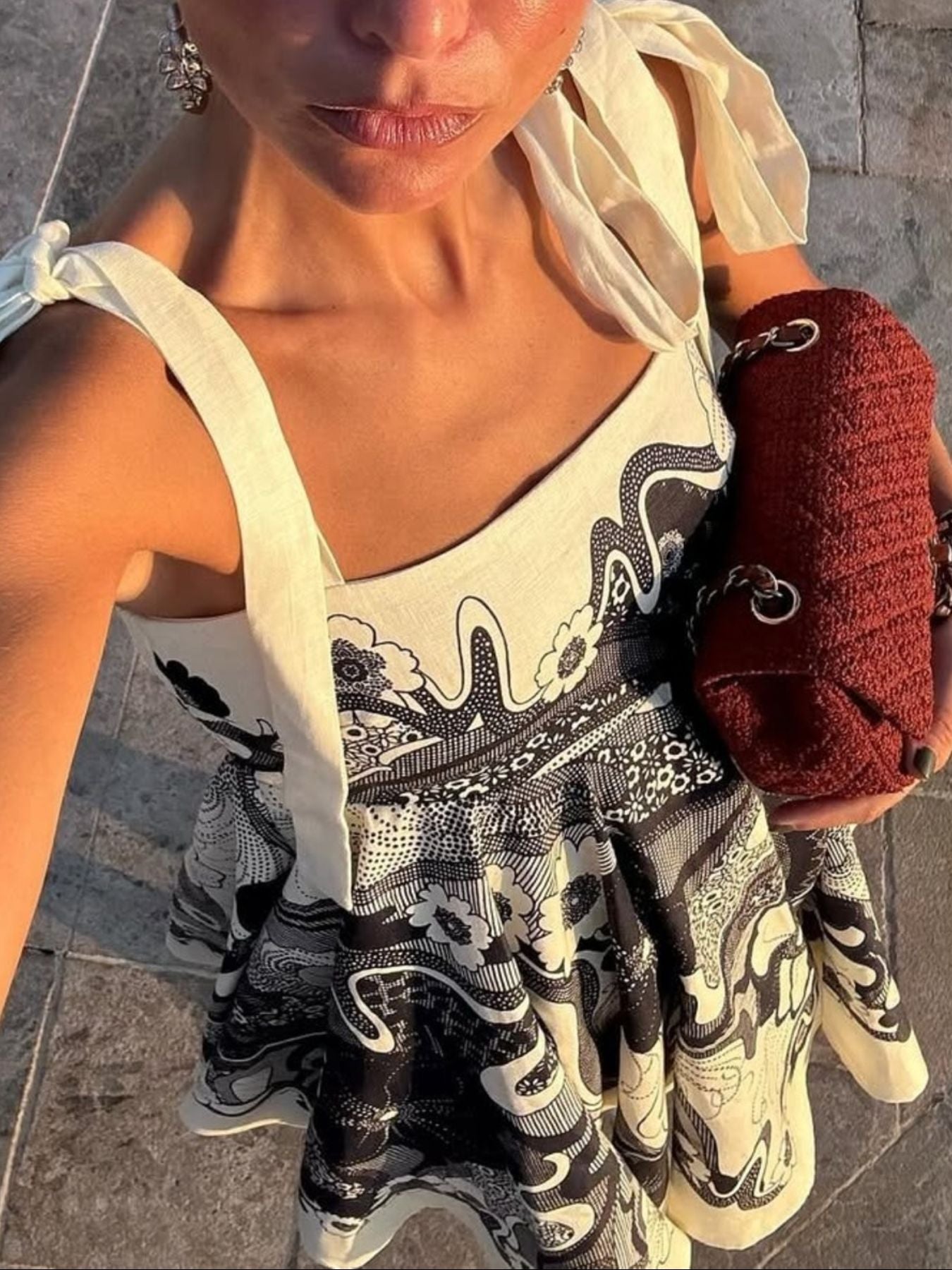 Printed tie-shoulder mini dress in cream with black paisley print; lightweight fabric