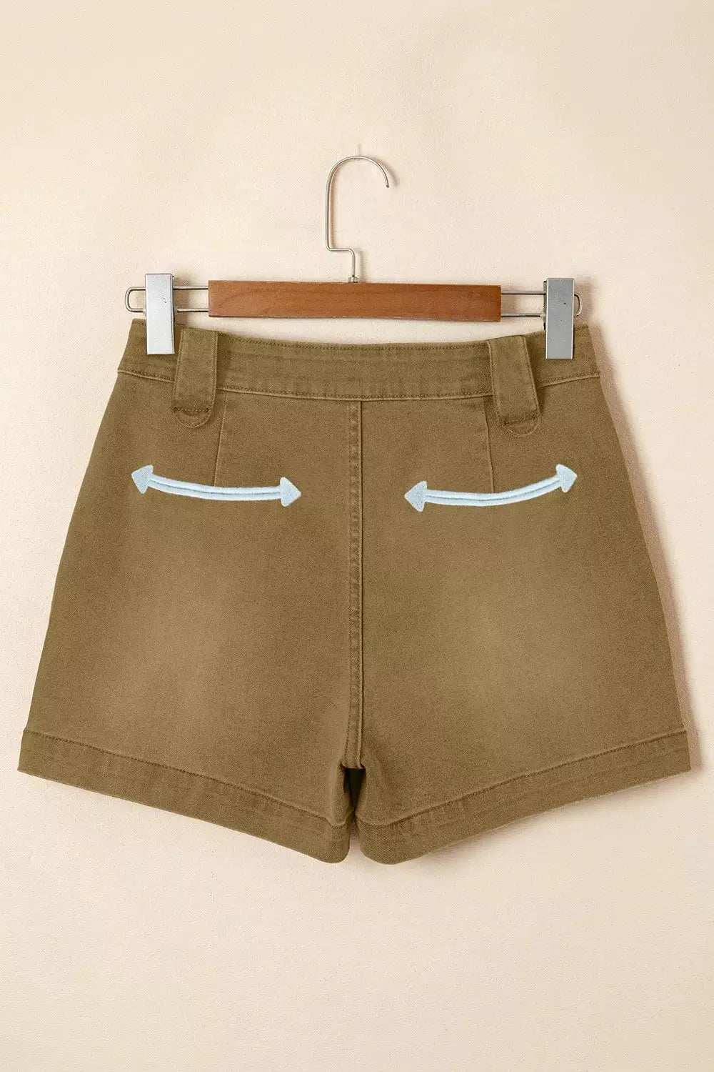 Women's Western denim shorts in tan with light-blue curved arrow embroidery on back pockets