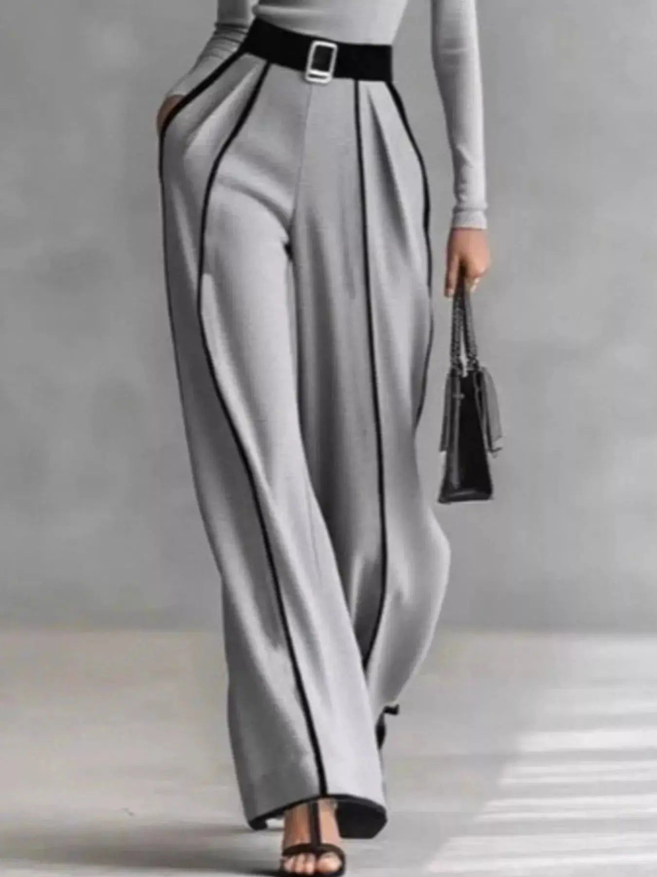 Turtleneck long-sleeve top and contrast pants set in gray with black piping and belt.